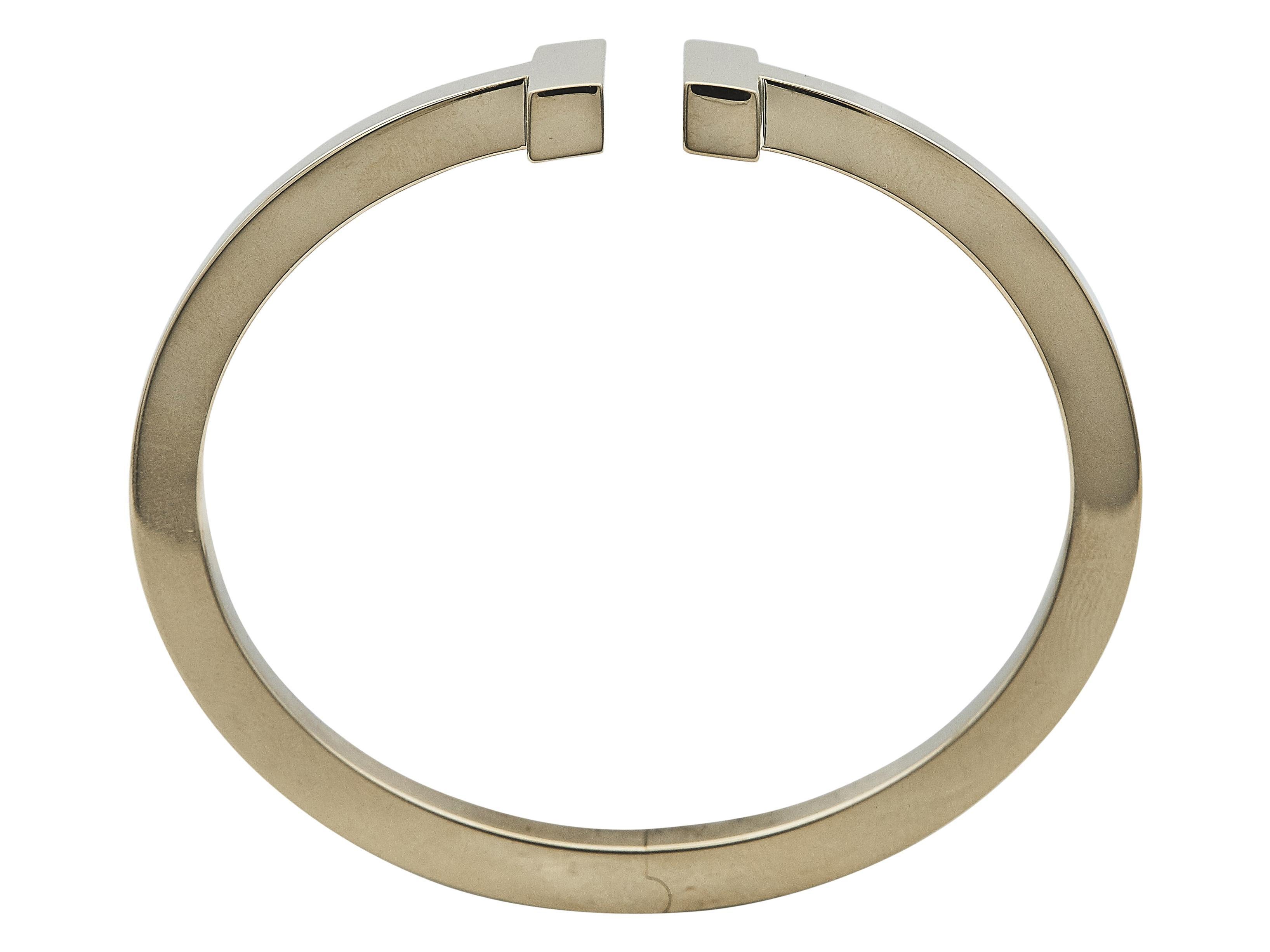 The bracelet: A Tiffany & Co. Tiffany T Square bangle bracelet designed in eighteen karat yellow gold. The interior circumference accommodates a wrist size of 6.5 inches.

More on the collection: The Tiffany T collection by Tiffany & Co. is a modern