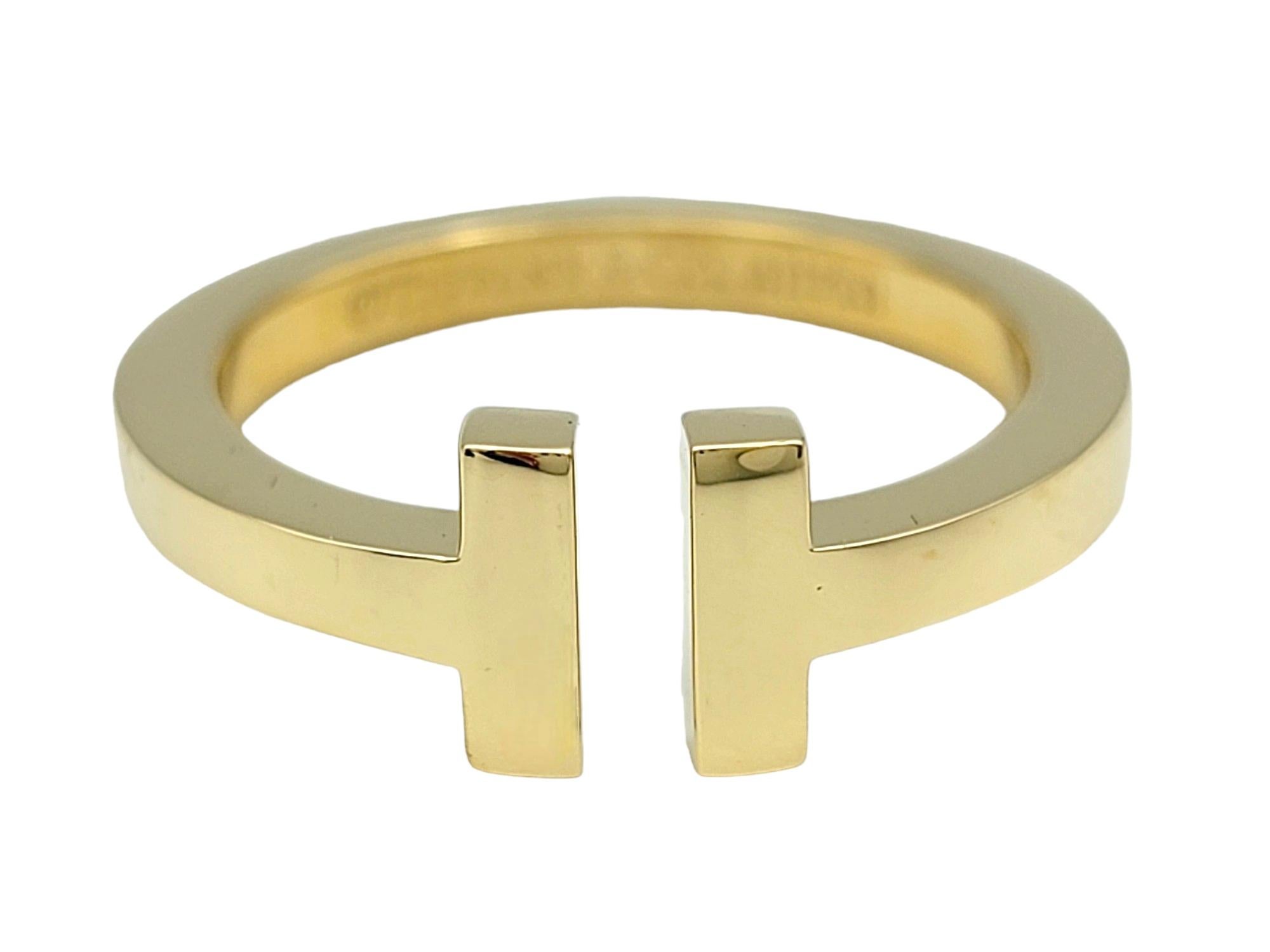 Ring Size: 8.75

Crafted by the renowned Tiffany & Co., this exquisite Tiffany T band ring is a timeless symbol of elegance and sophistication. Meticulously crafted from lustrous 18 karat yellow gold, it boasts a sleek and minimalist design that