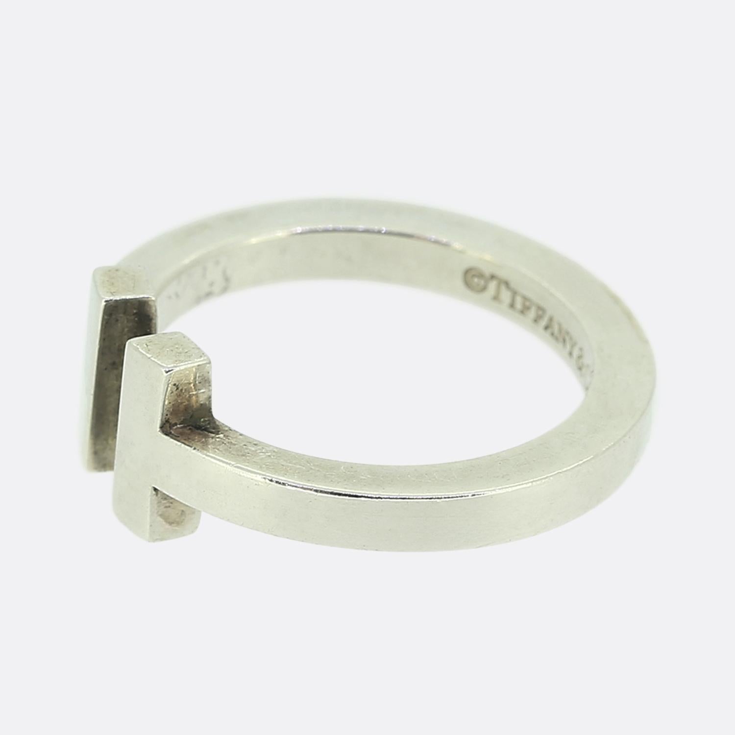Here we have sleek statement ring from the world renowned luxury jewellery designer, Tiffany & Co. This sterling silver piece forms part of the 'Tiffany T' collection and showcases the iconic open T motif atop a square shaped band.

Condition: Used