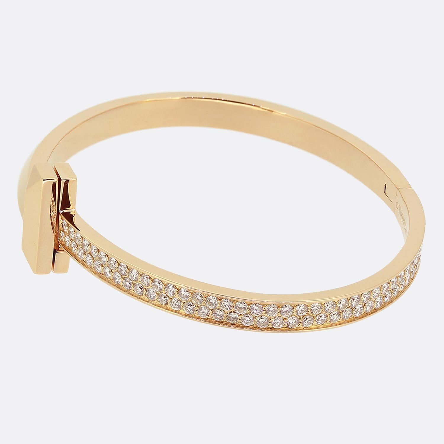Here we have charming diamond bracelet from the world renowned luxury jewellery designer, Tiffany & Co. This 18ct rose gold piece forms part of the 'Tiffany T' collection and showcases the iconic T motif at the centre flanked on one side by two rows
