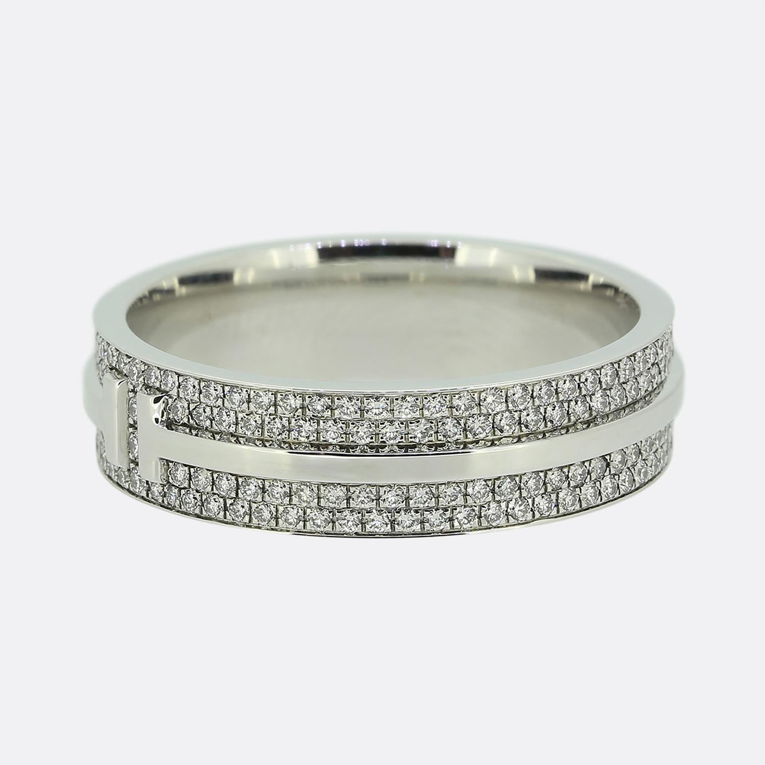 Here we have a fabulously crafted diamond band ring from the world renowned jewellery designer Tiffany & Co. This ring forms part of their T True collection and is the wider model featuring the iconic T motif around the entire band with two rows of