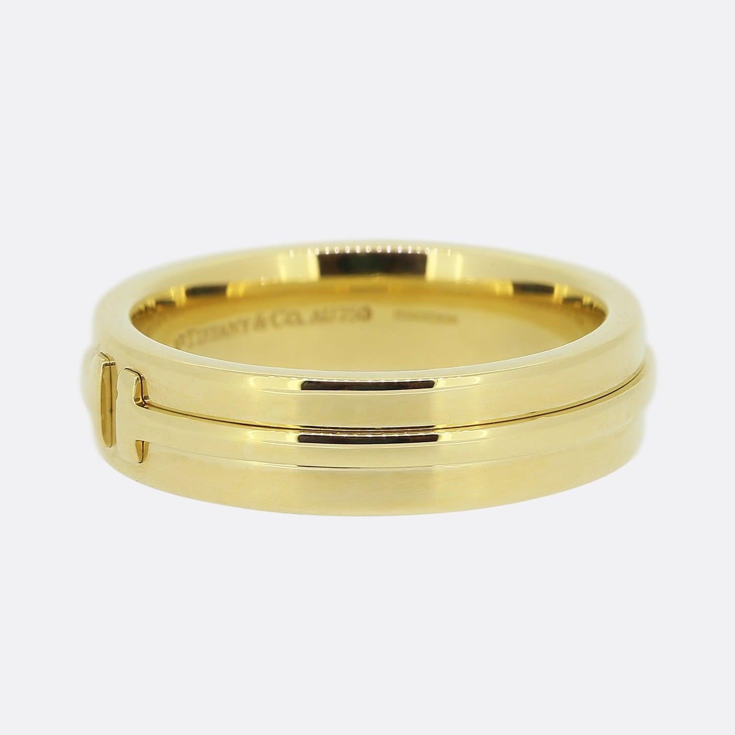 Here we have a classic 18ct yellow gold band ring from the world renowned luxury jewellery designer, Tiffany & Co. This piece forms part of the T Tiffany collection with bold lines highlighting the powerful form of the letter 