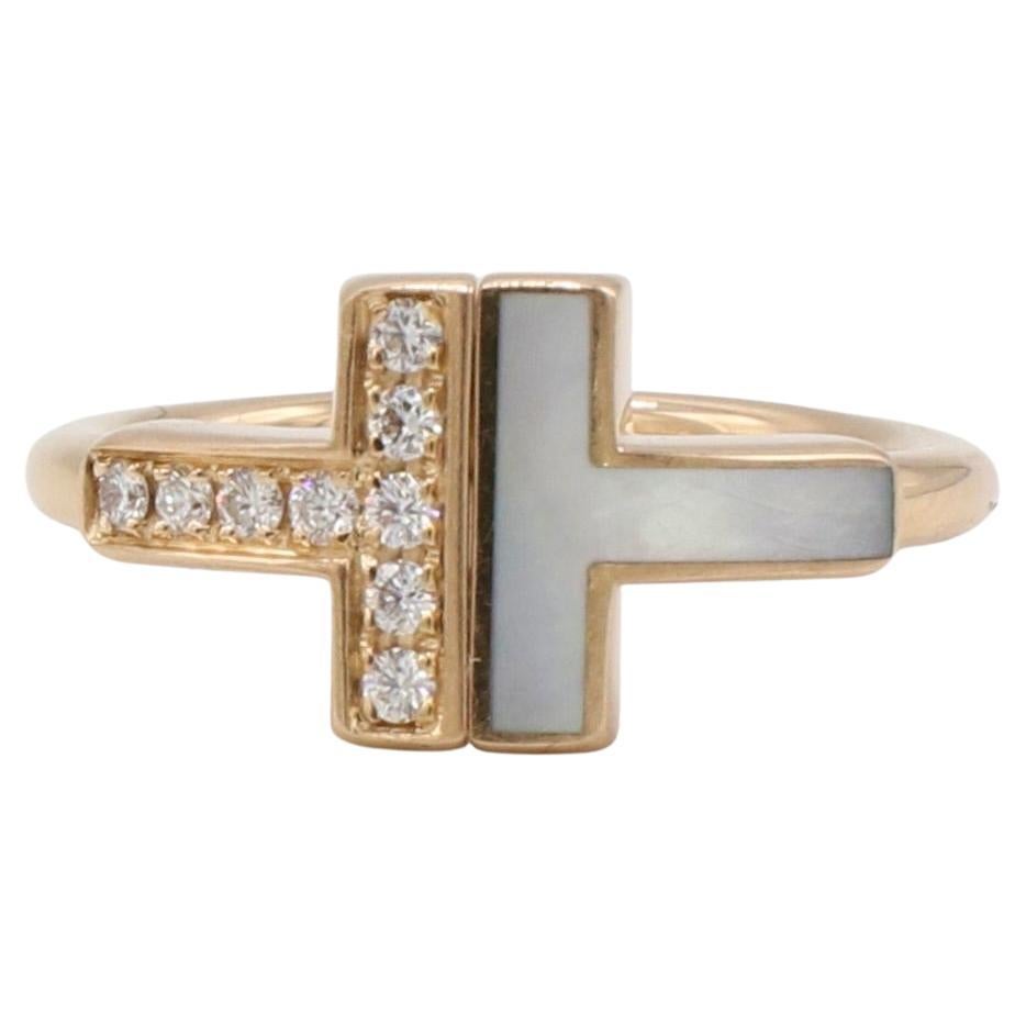 Tiffany & Co. Tiffany T. Wire Ring 18K Rose Gold Natural Diamonds Mother Pearl 

Metal: 18k rose gold
Weight: 3.25 grams
Diamonds: Carat total weight .07 natural round diamonds D-F VVS-VS
Retail: $2,675
Size: 3.5 US (great pinky ring!)
Signed: