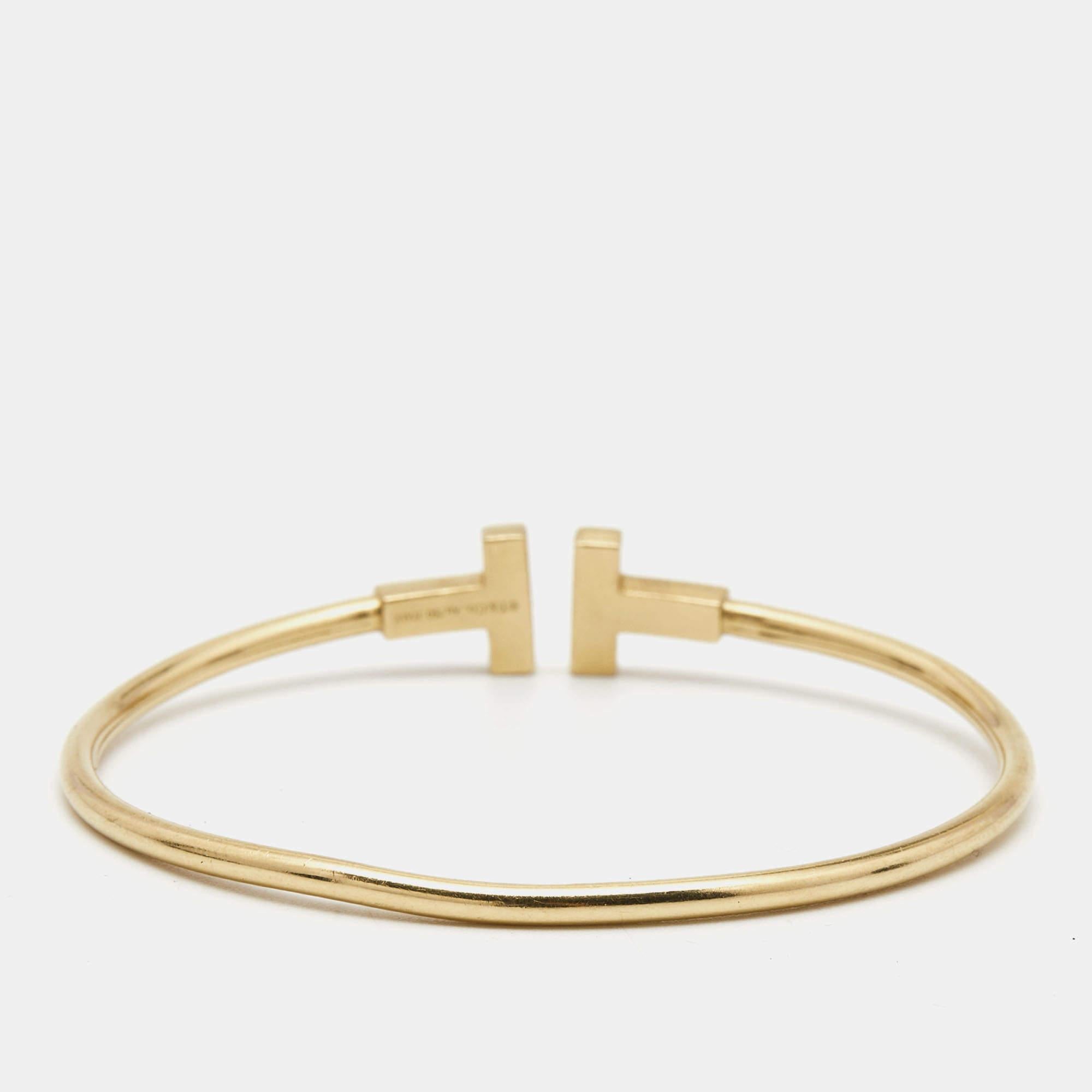 This wire bracelet from Tiffany is made from 18k yellow gold. The narrow wire of the bracelet curves beautifully around your wrist. Finished with the signature ‘T’ for Tiffany’s, this is an easy slip-on accessory.

Includes: Original Case

