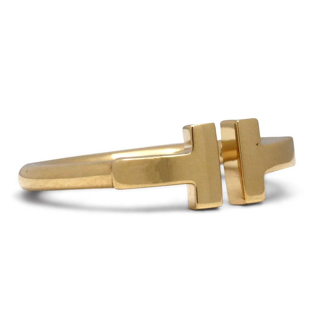 Authentic Tiffany & Co. 'Tiffany T Wire' ring crafted in 18 karat yellow gold. This stunning ring features a bold 
