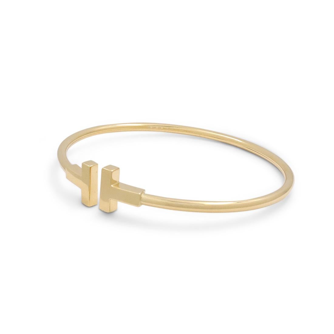 Authentic Tiffany & Co. 'Tiffany T' wire bracelet crafted in 18 karat yellow gold. Signed T&Co., Au750. Will fit up to 6.25 inch wrist. The bracelet is not presented with the original box or papers. CIRCA 2010s.

Brand: Tiffany & Co.
Collection: