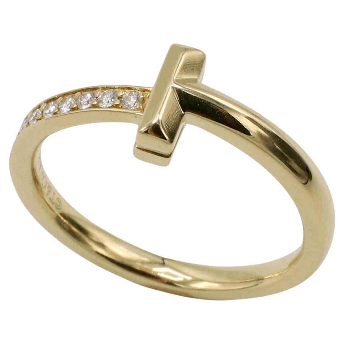 Tiffany & Co. Tiffany T1 Ring in Yellow Gold Natural Diamonds Band Ring 
Metal: 18k yellow gold
Weight: 4.26 grams
Diamonds: Approx. .08 CTW E-F VS round natural diamonds
Size: 6.5 (US)
Signed: ©T&Co. Au750 ITALY
Band: 2.5mm
Retail: $2,350 USD