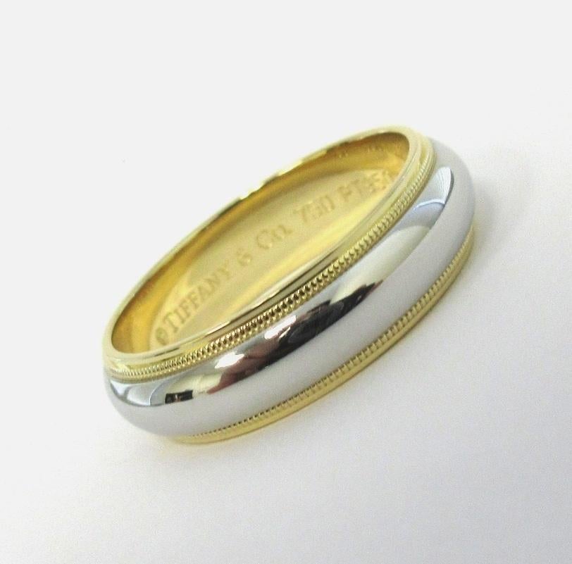 TIFFANY & Co. Together Platinum 18K Gold 6mm Milgrain Wedding Band Ring 8.5

Metal: Platinum and 18K Yellow Gold
Size: 8.5
Band Width: 6mm
Weight: 10.0 grams 
Hallmark: ©TIFFANY&CO. 750 PT950
Condition: Excellent condition

Authenticity Guaranteed