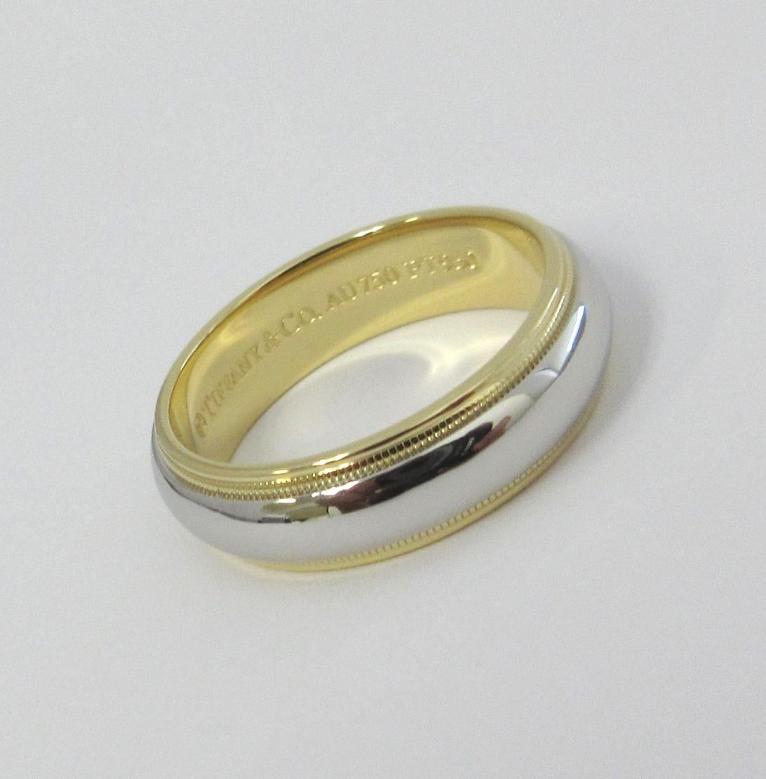 TIFFANY & Co. Together Platinum 18K Gold 6mm Milgrain Wedding Band Ring 8.5

Metal: Platinum and 18K Yellow Gold
Size: 8.5
Band Width: 6mm
Weight: 10.10 grams 
Hallmark: ©TIFFANY&CO. AU750 PT950
Condition: Excellent condition, like new

Authenticity