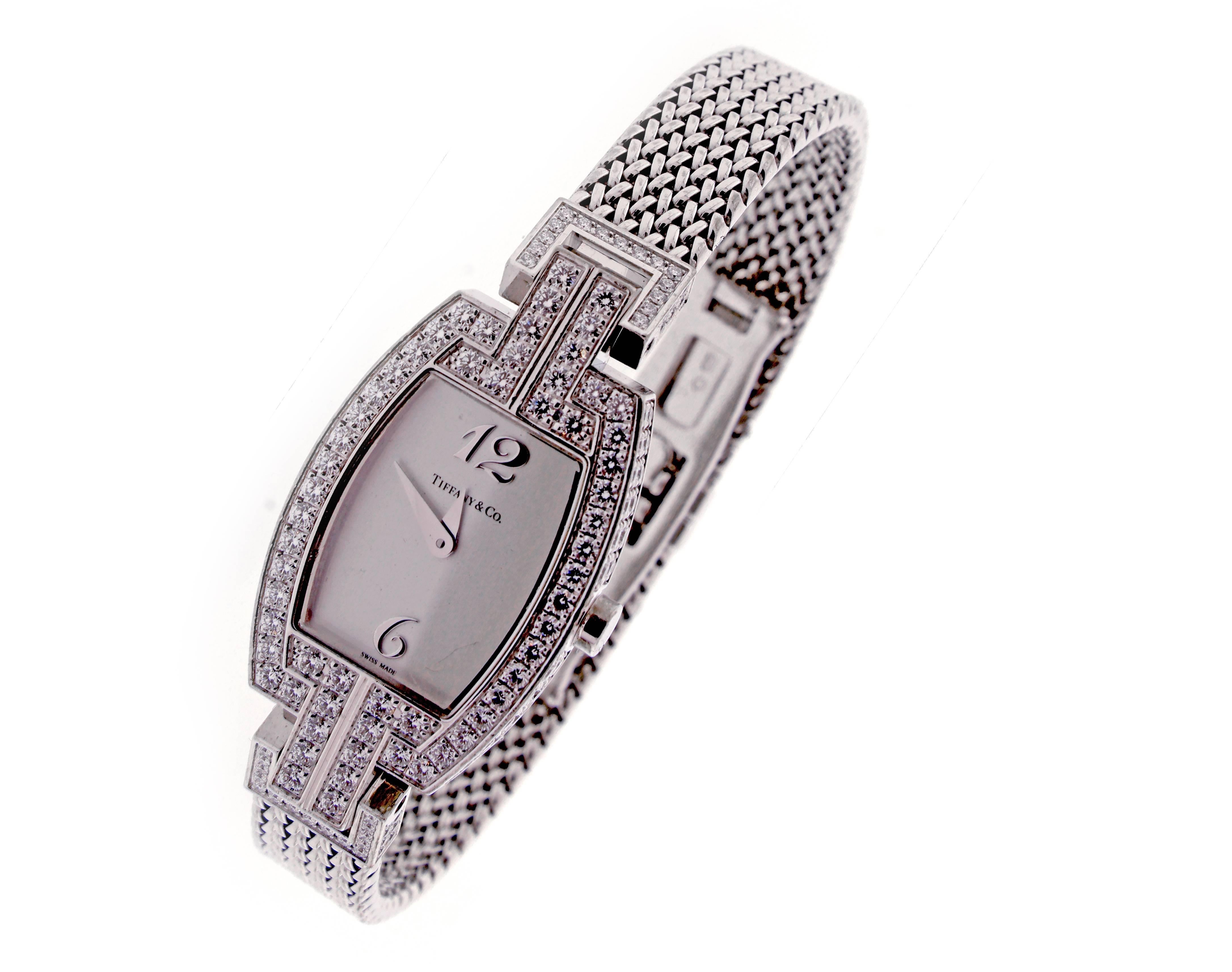 Fro, Tiffany & Co. thier elegant Tonneau ladies 18 Karat watch. The watch is set with 168 diamond weighing 2.04 carats.
 The case measures 22mm x 18mm with a 9mm strap and double deployment clasp. High-grade quartz movement and sapphire crystal.
