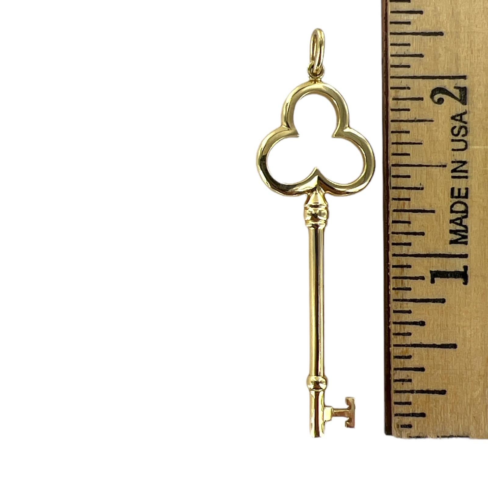 Tiffany & Co. popular key pendant crafted in 18 karat yellow gold. The trefoil design is on top, and the key meaures 2.00 inches in length and .75 inches in width. Signed Tiffany & Co. 750. Does not come with chain. 
