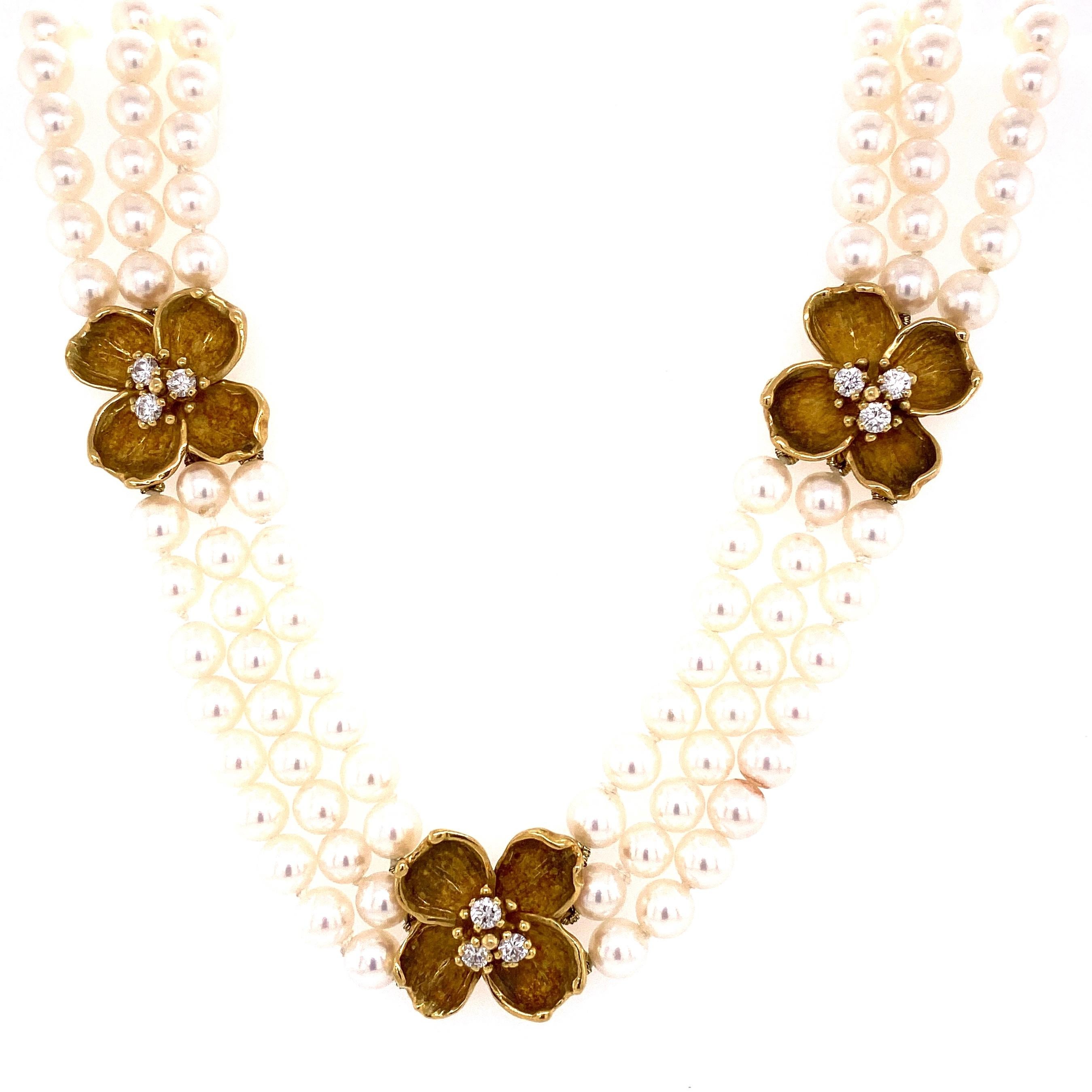 
Simply Beautiful and finely detailed TIFFANY & CO Triple Strand size Pearl Necklace with Four 750/18 Karat Yellow Gold Flower Stations set with Diamonds, approx. 1.00 total Carat weight. Approx. size of pearls:  5.5mm and approx. length of necklace