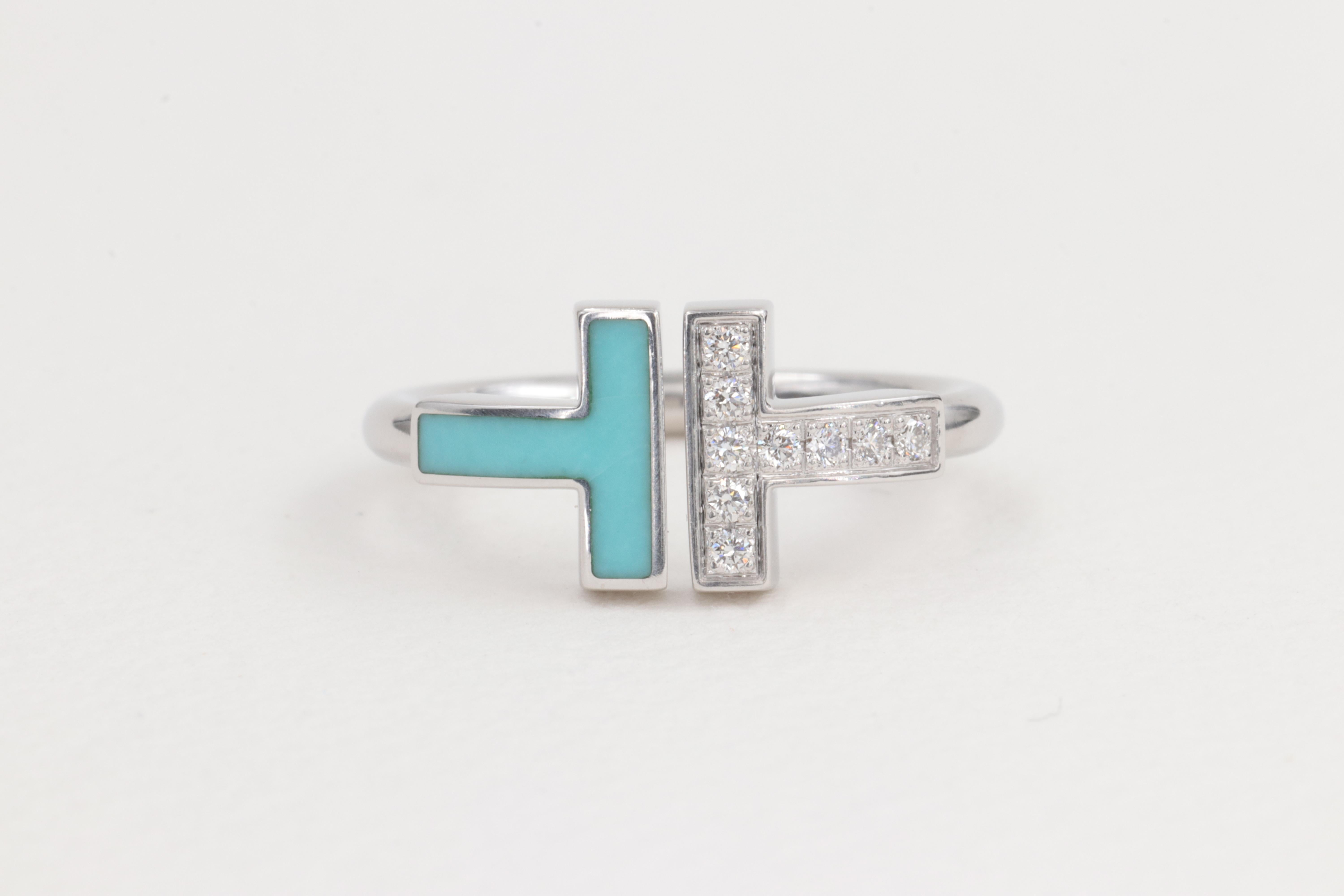 Tiffany & Co. Turquoise and Diamond T Wire Ring in 18 Karat White Gold

Diamonds :

Diamonds - 10 Stones = 0.10ctw 
Color -  D - F 
Clarities - VS+

Ring:

Metal - 18 Karat White Gold 
Weight - 4.2 Grams 

Size - 4.5 US 
      