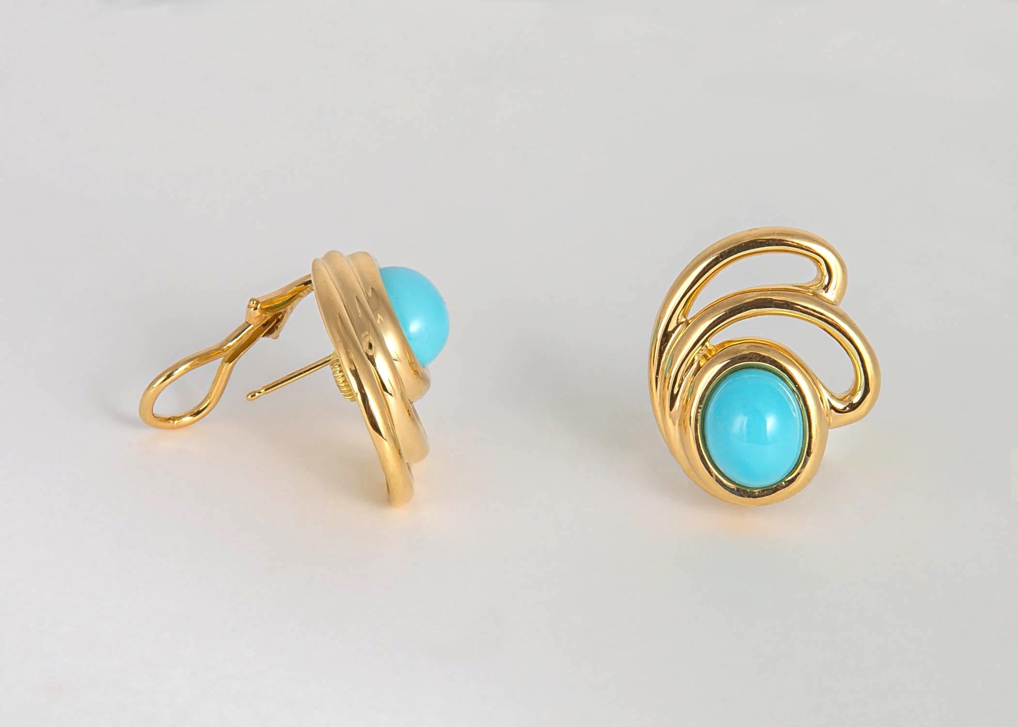 Beautiful ribbons of 18k gold frame a matched pair of vivid blue turquoise. Tiffany quality and design all the way. 1 inch in size.