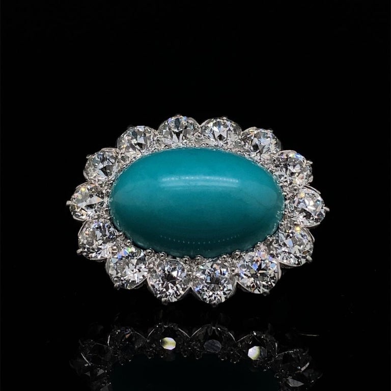 A Tiffany & Co turquoise and diamond brooch in 18 karat yellow gold and platinum

Circa 1900, this outstanding brooch is set with a superb oval turquoise cabochon measuring approximately 26.0 by 16.0 by 7.0 mm.
The centre turquoise is framed by 18