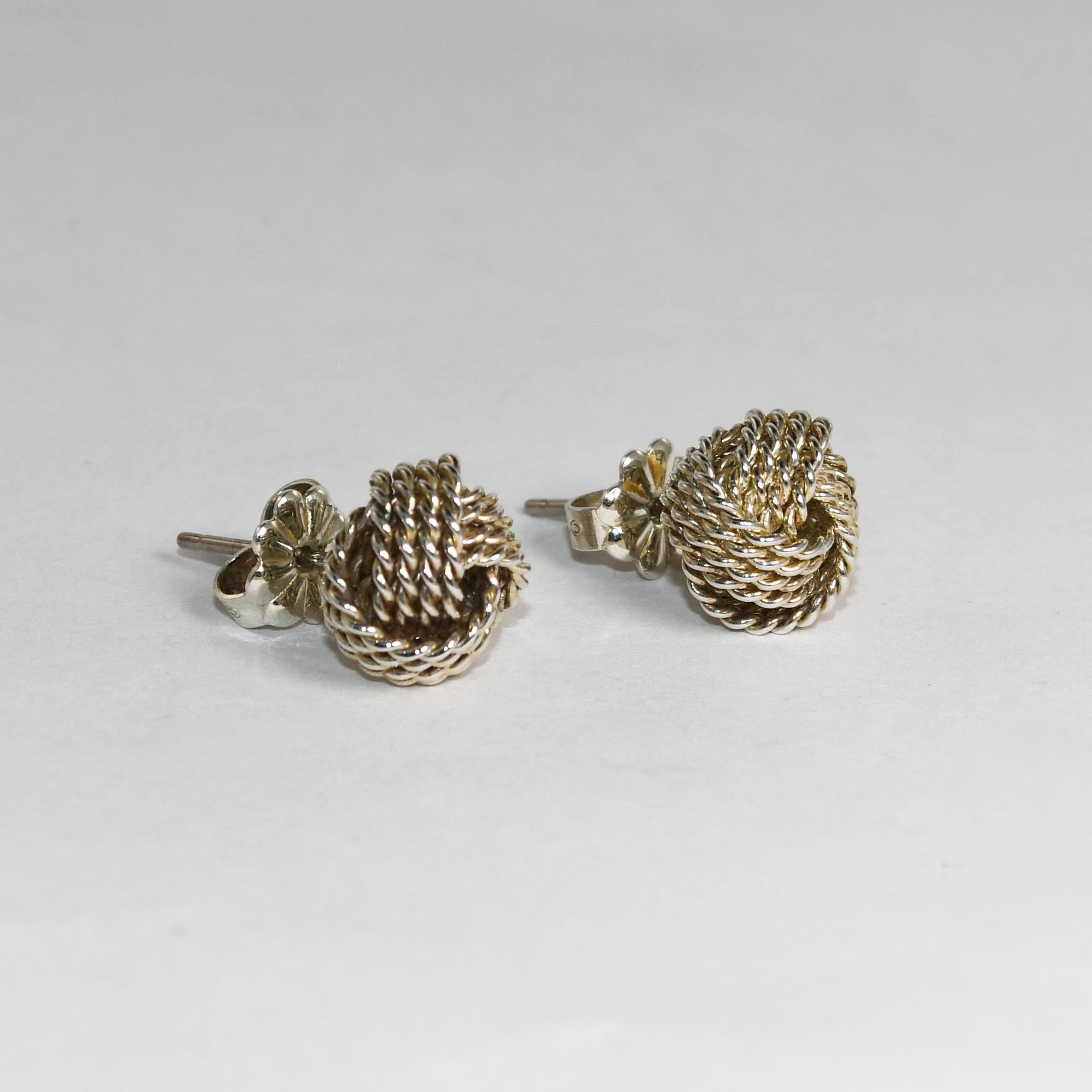 Ladies Tiffany & Co silver, twist knot earrings.
Stamped T& Co 925 and weigh 2.8 grams.
The knots measure 9mm wide.
There are posts with friction backs for pierce ears.
Comes with Tiffany blue bag.
Overall, very good condition.