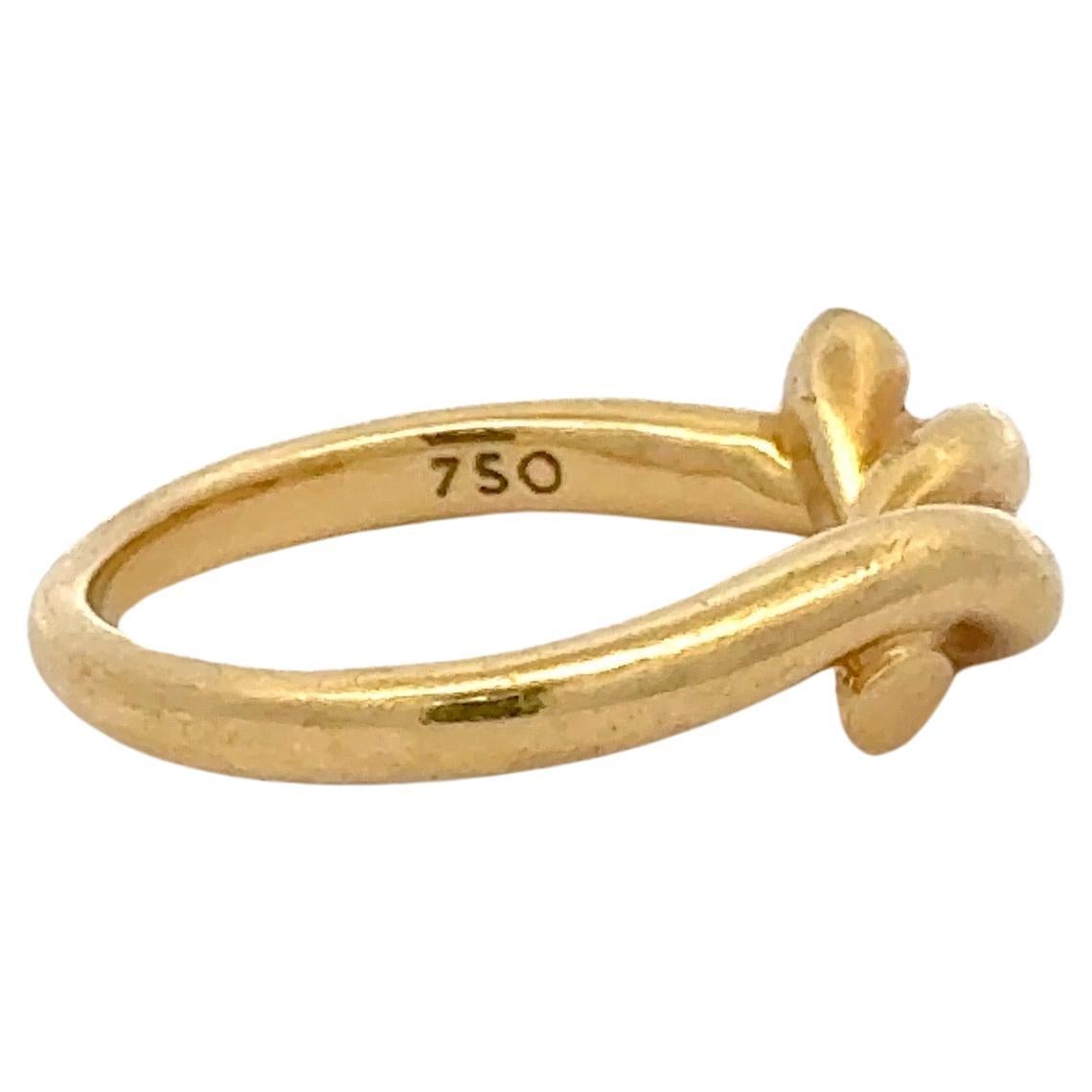 Tiffany & Co, 18 karat yellow gold ring featuring a twisted knot motif weighing 5.4 Grams.
Size 5