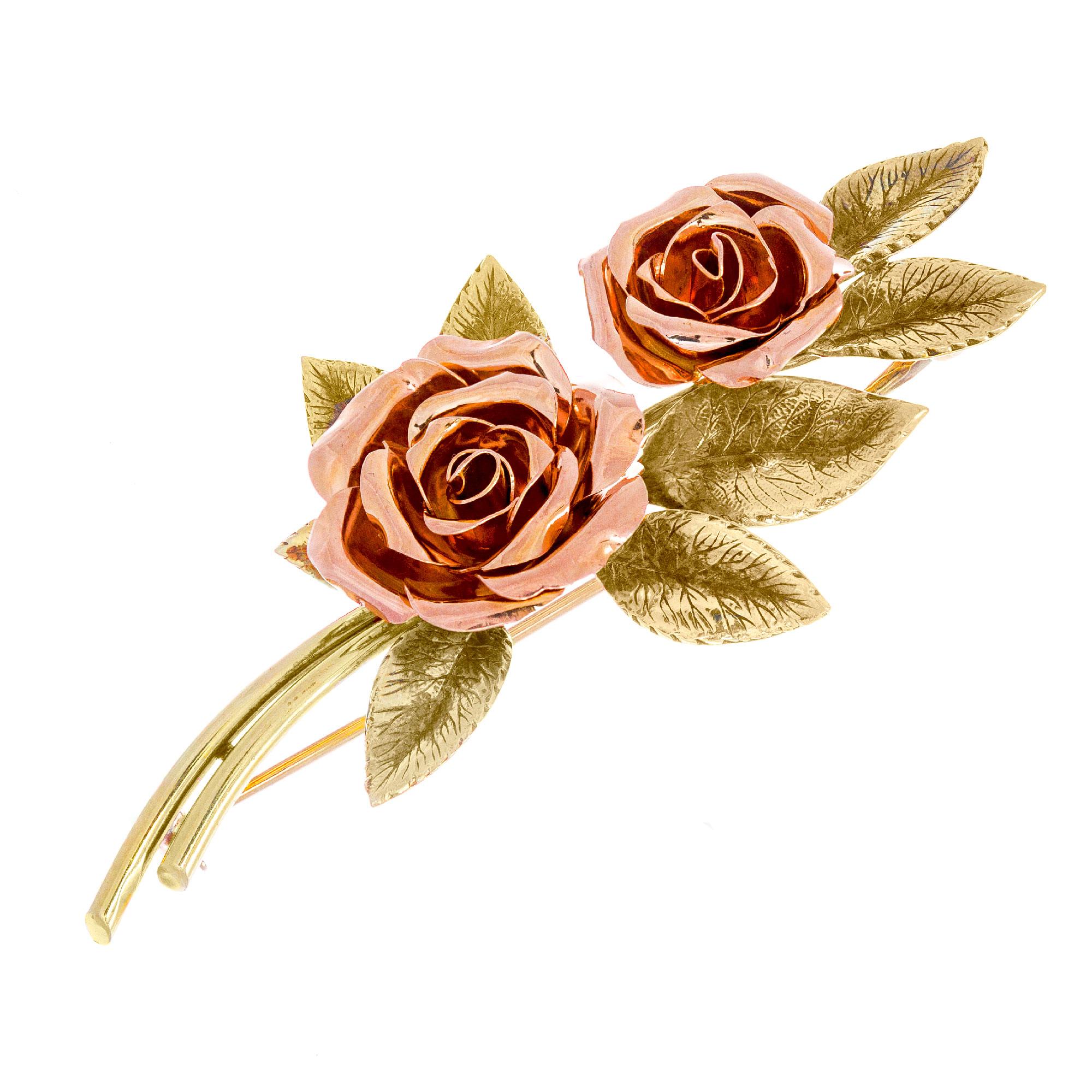 Tiffany & Co two tone gold double rose brooch.

14k yellow gold 
14k rose gold 
Stamped: 14k
Hallmark: Tiffany 
17.7 grams
Top to bottom: 71.2mm or 2.75 Inches
Width: 33.6mm or 1/3 Inch
Depth or thickness: 10.9mm

