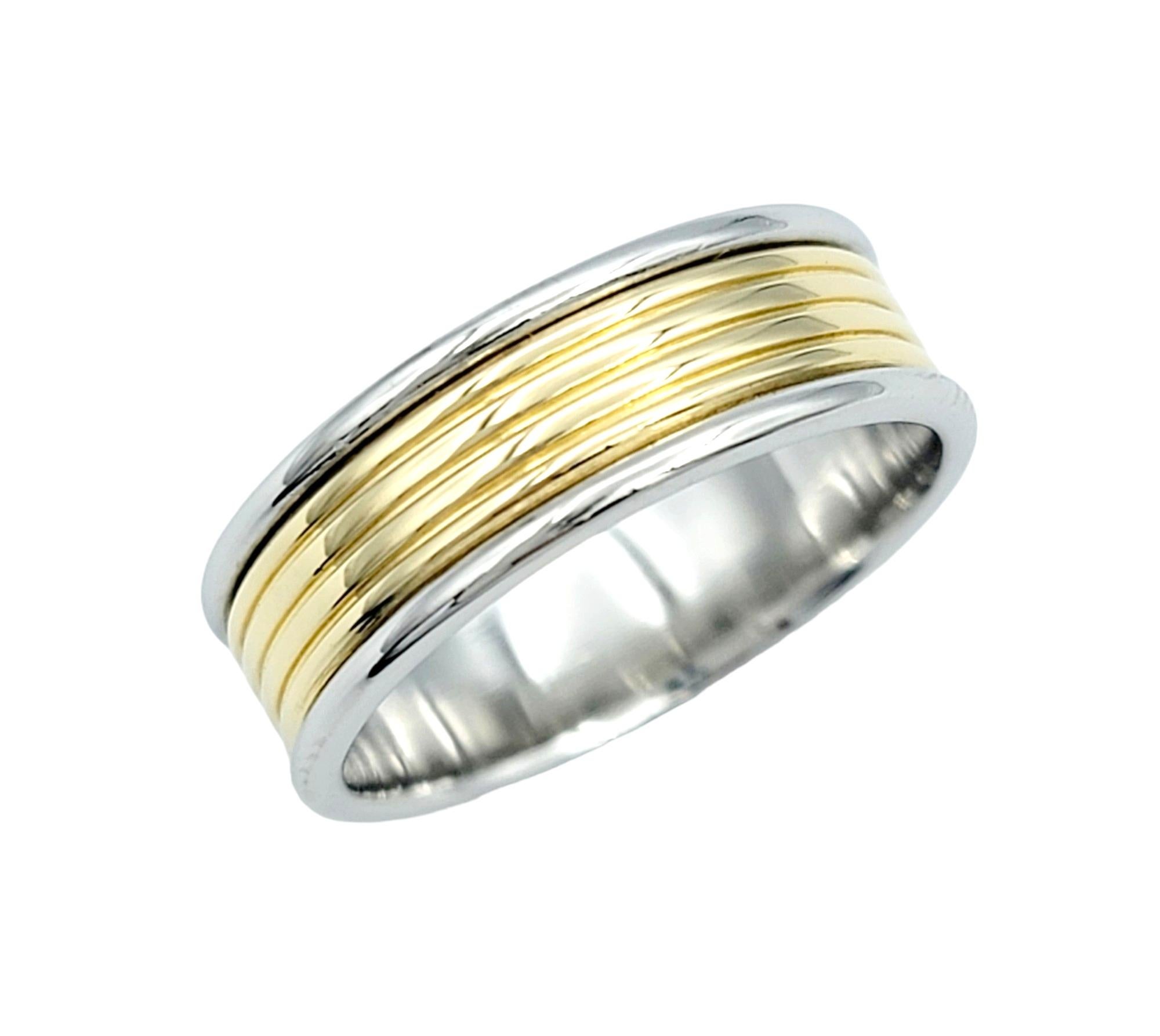 Ring Size: 5.5

This elegant Tiffany & Co. band ring is a masterful combination of platinum and 18 karat yellow gold, creating a timeless and sophisticated piece. The outer edges of the ring crafted in platinum provide durability and a sleek