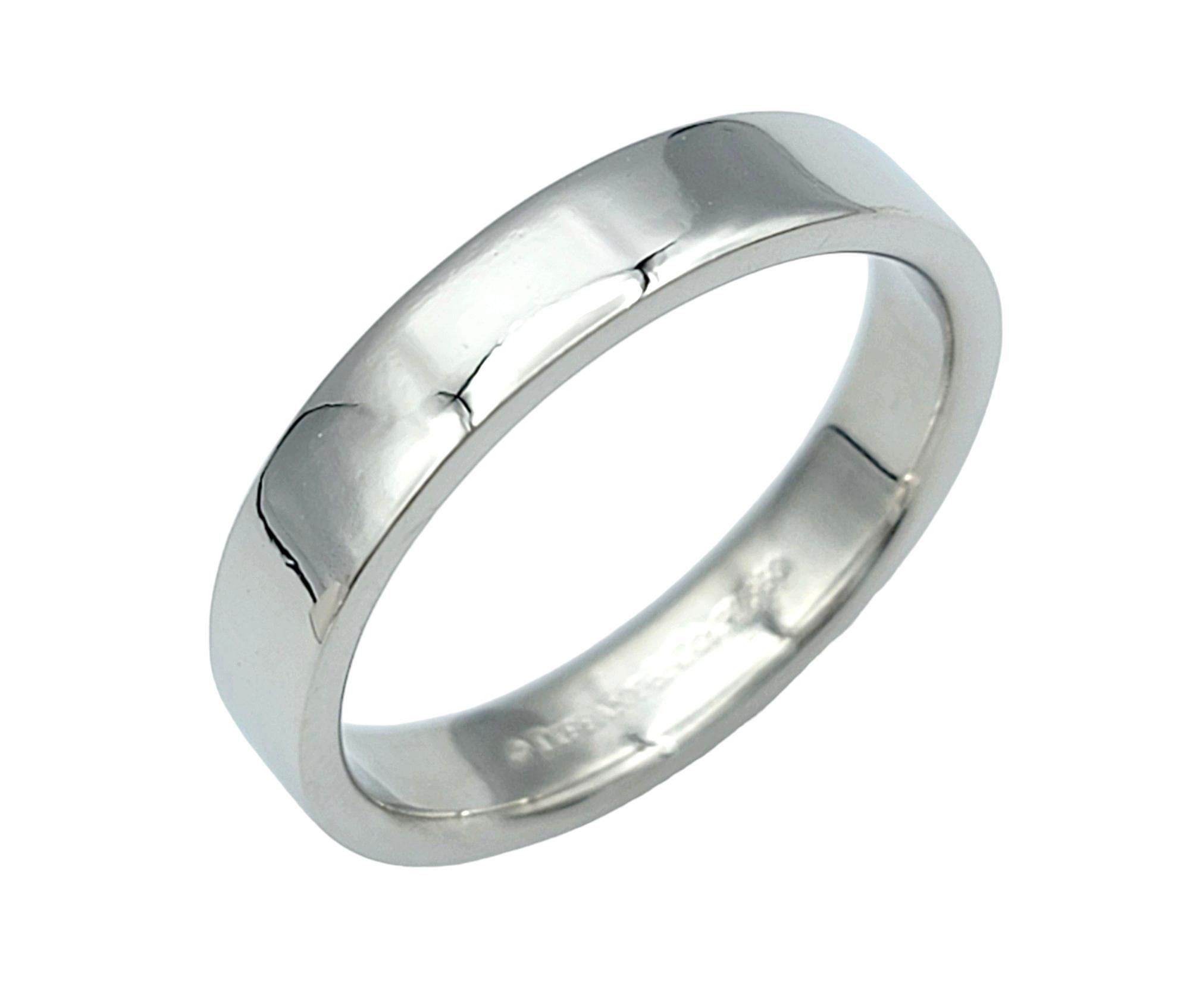 Ring Size: 6.5

This simple yet elegant Tiffany & Co. platinum band ring is a timeless accessory that exudes sophistication. Crafted from high-quality platinum, the ring boasts a sleek and polished finish that catches the light with every movement.
