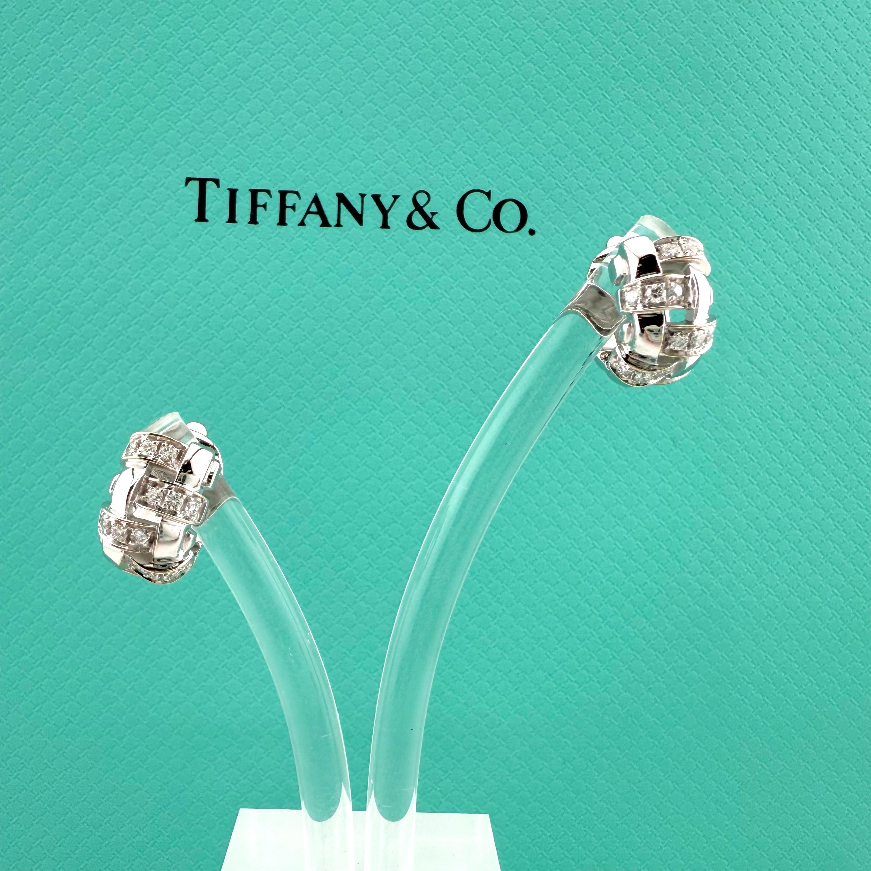 Tiffany & Co.
Style: Vannerie Basket Weave Diamond Earrings
Backing:  Paddle backs with Posts
Metal:  18kt White Gold
Dimensions:  11 X 10 X 11.3 MM
Total Carat Weight:  0.48 CTS
Diamond Shape:  Round Brilliant Diamonds
Diamond Color & Clarity:  G -