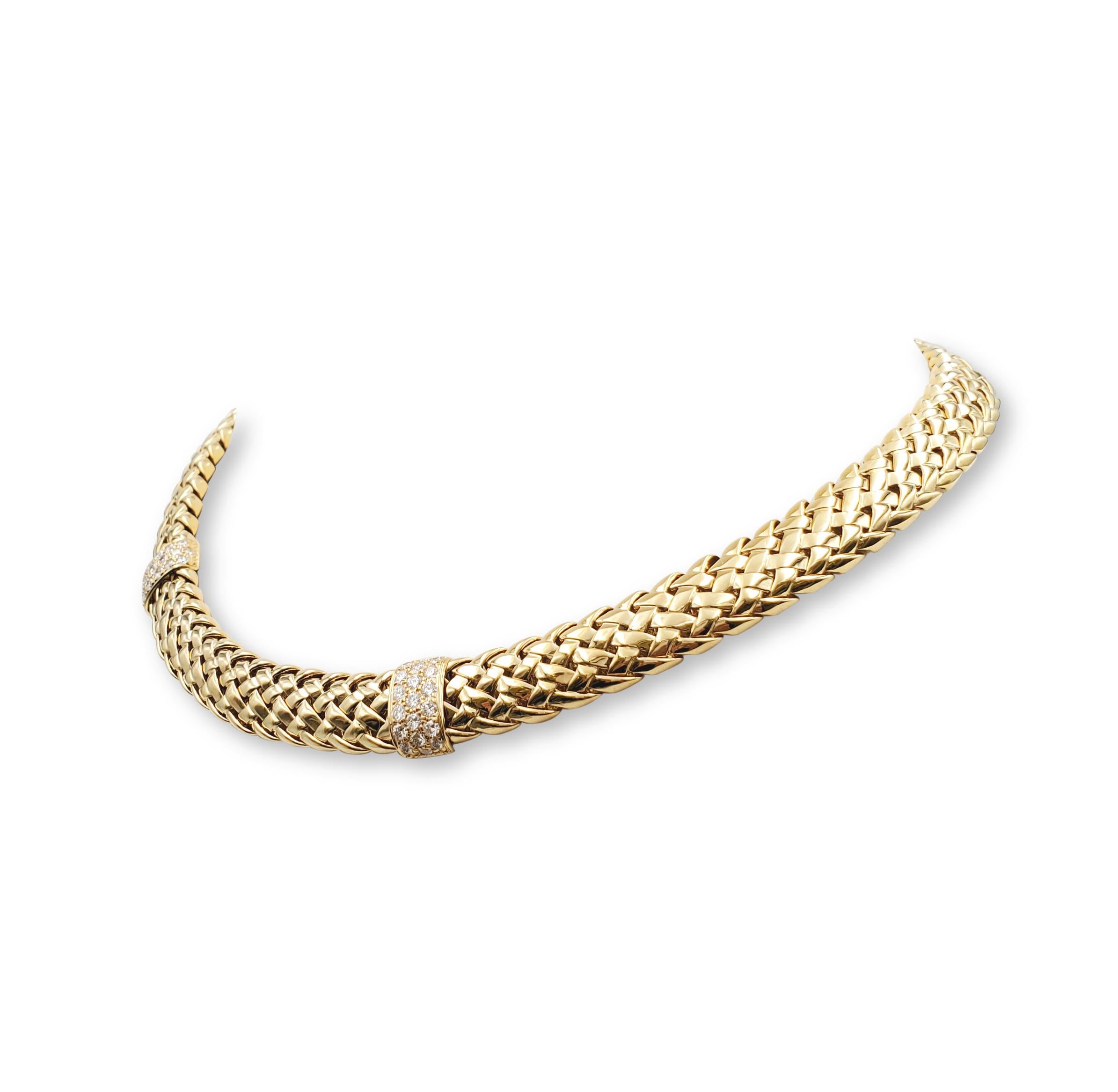 Authentic Tiffany & Co. Vannerie necklace crafted in 18 karat yellow.   The woven high polished gold choker is accented by two stations set with round cut diamonds of an estimated 1.90 carats total weight.  The necklace measures 15 1/2 inches in