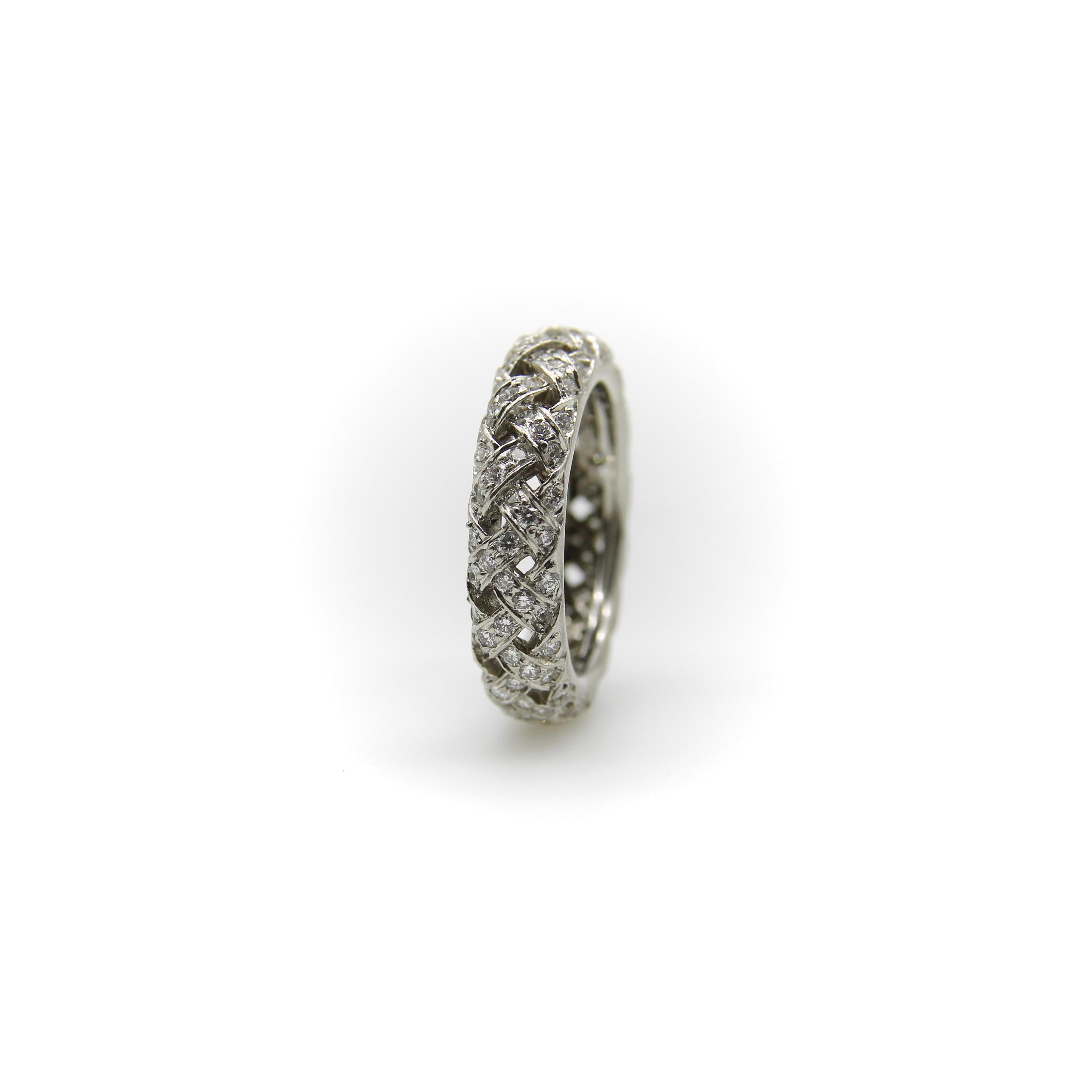 An instant classic, this basket weave ring by Tiffany & Co. exudes class and sophistication. It is encrusted with diamonds bead set into a basket weave pattern with open work, making for a beautiful intricate ring. The eternity band brings