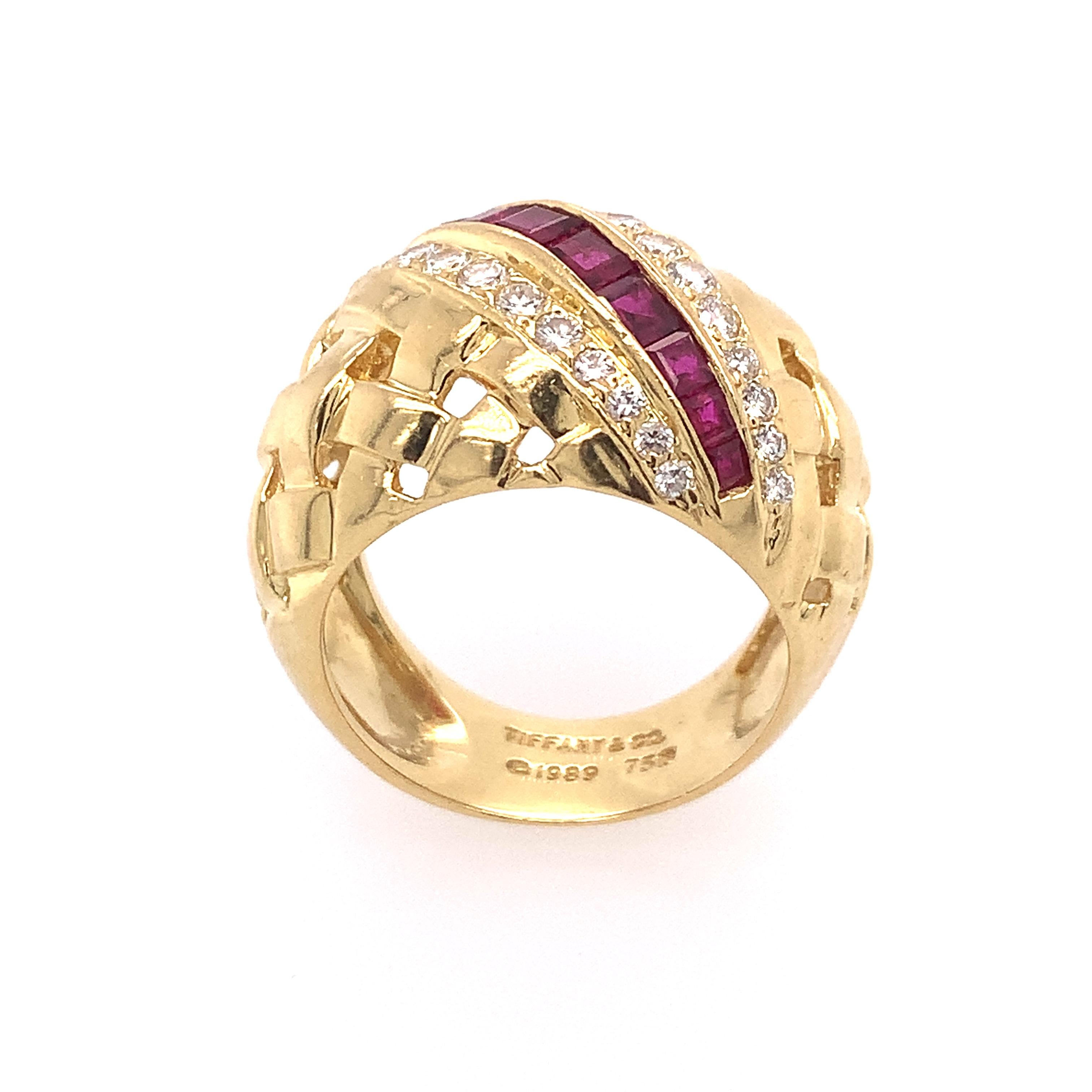 Vintage Tiffany & Co. 18K Yellow gold Vannerie dome ring featuring a woven motif set with twenty-eight (28) brilliant-cut round diamonds weighing an estimated 0.75 carats and eleven (11) square step-cut rubies weighing an estimated 0.75 carats. The