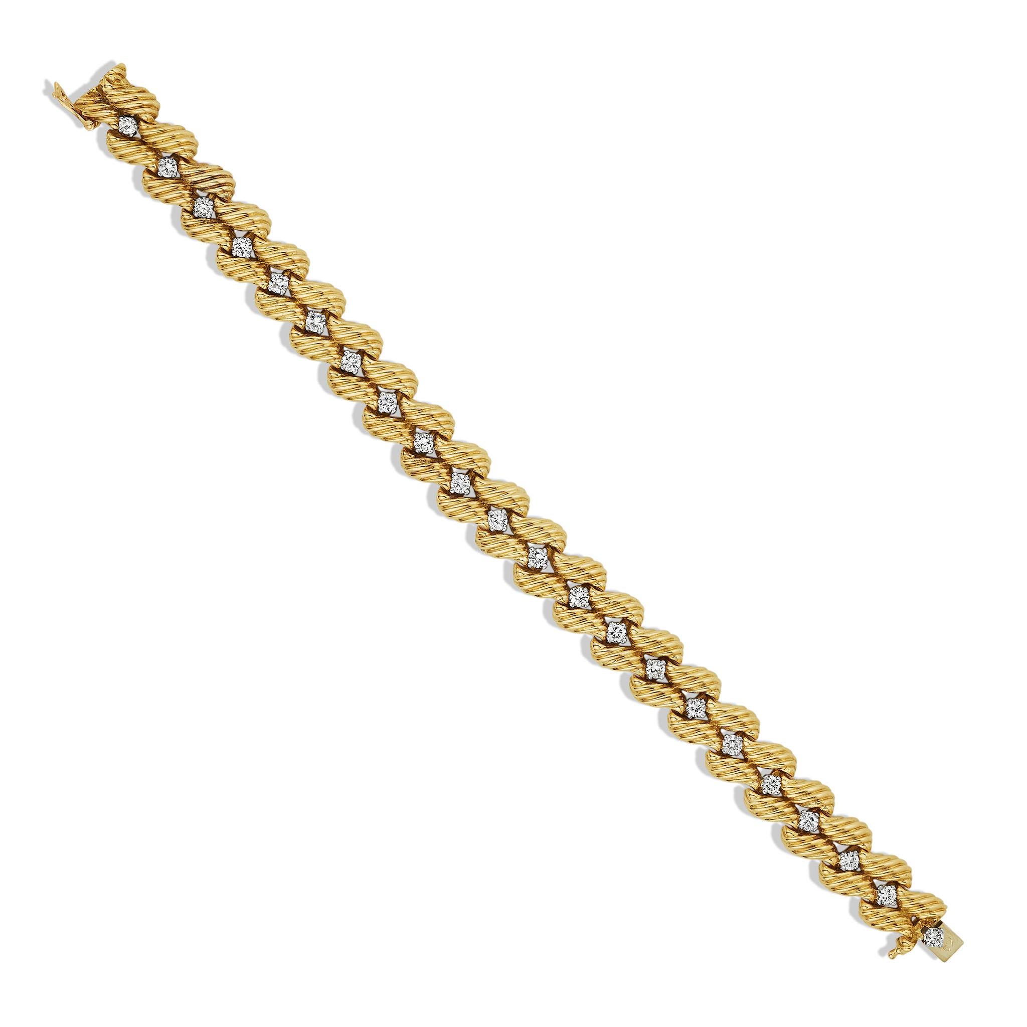 Created for Tiffany & Co. by Verger Frères, this 1960s bracelet is composed of 18K gold and diamonds. It is designed as a double line of ribbed, stylized leaf-form highlighted by 22 brilliant-cut diamonds. Beautifully crafted for ideal weight and