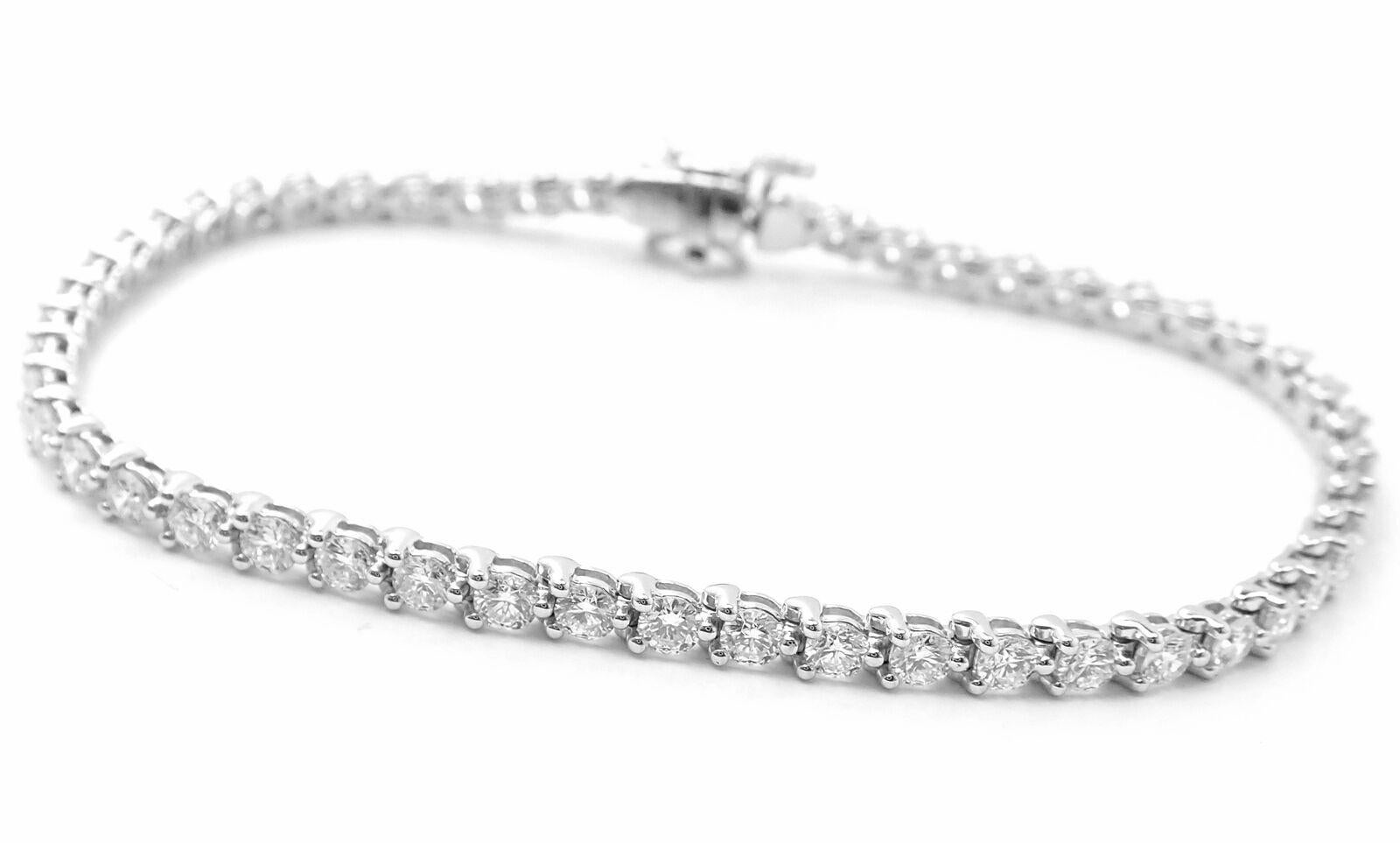 Platinum Diamond Line Tennis Bracelet by Tiffany & Co from Victoria collection.
With 51 round brilliant cut diamonds VS1 clarity, E color total weight approx. 3.08ct
4 marque cut diamonds.
Details:
Weight: 11.7 grams
Length: 7