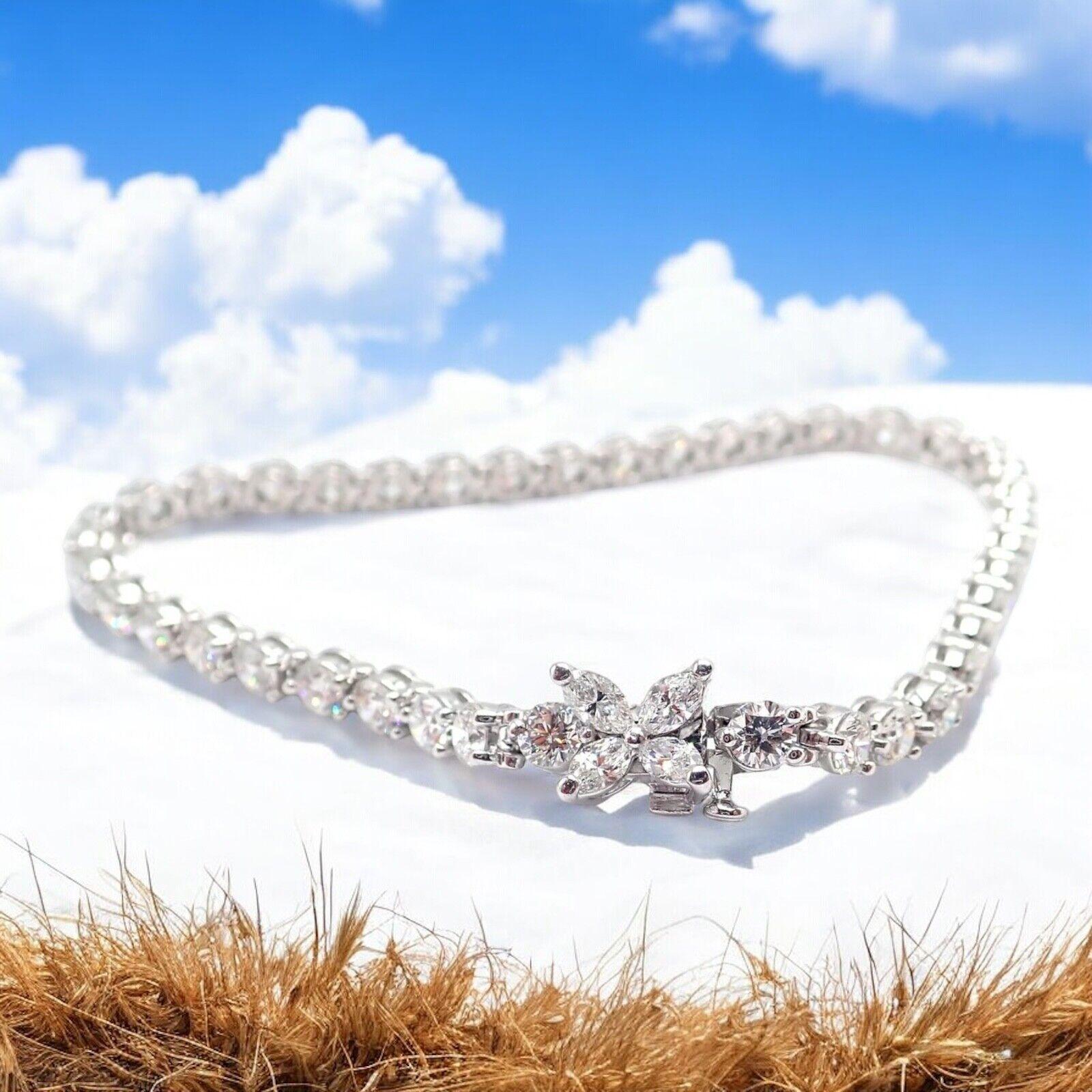 Platinum Diamond Line Tennis Bracelet by Tiffany & Co from Victoria collection.
With 40 round brilliant cut diamonds VS1 clarity, E color total weight approx. 6.22ct
4 marque cut diamonds VS1 clarity, E color total weight .31ct
Retail Price: $47,800