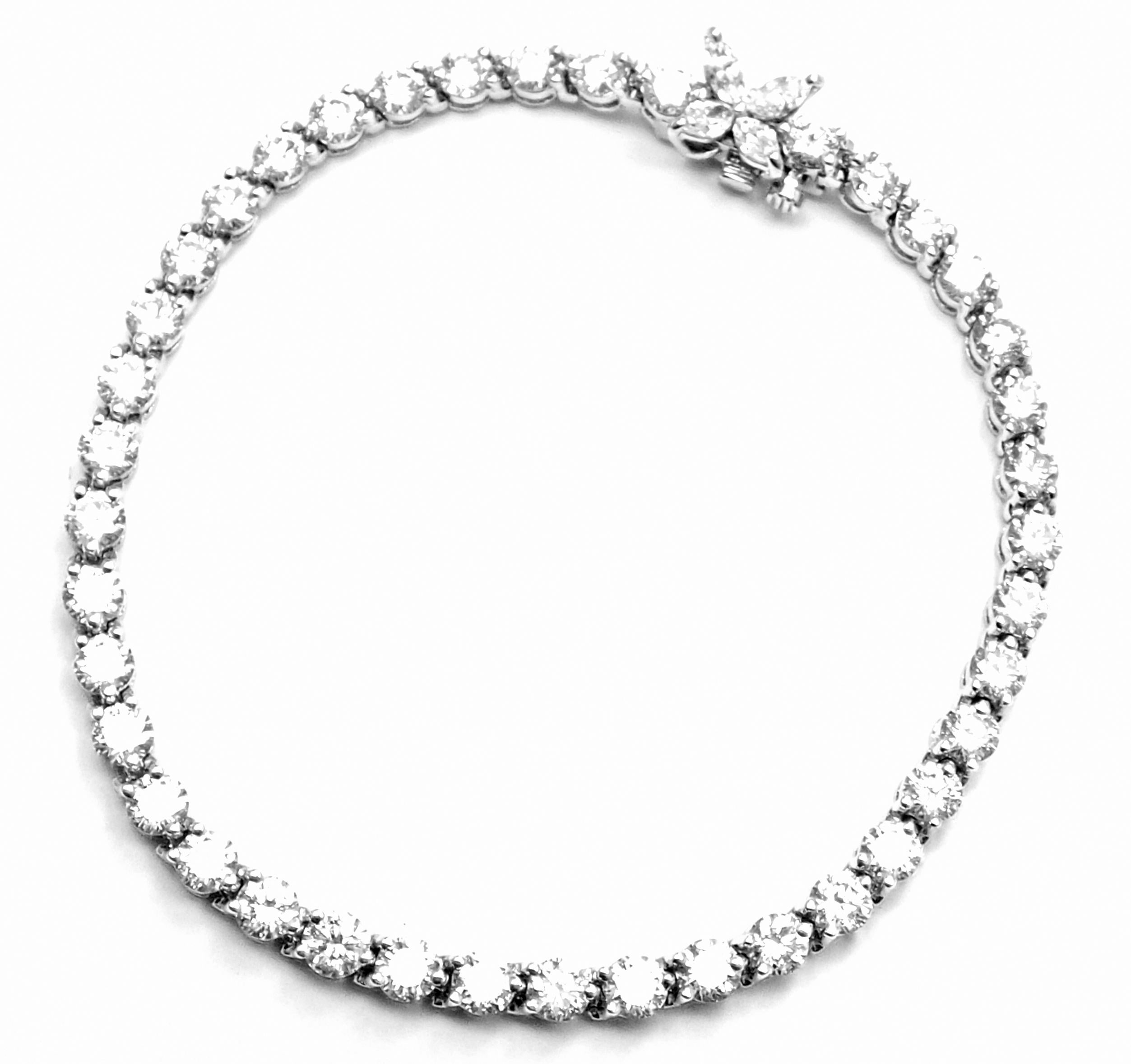 Platinum Diamond Line Tennis Bracelet by Tiffany & Co from Victoria collection.
With 40 round brilliant cut diamonds VS1 clarity, E color total weight approx. 6.22ct
4 marque cut diamonds VS1 clarity, E color total weight .31ct
Retail Price: $39,000