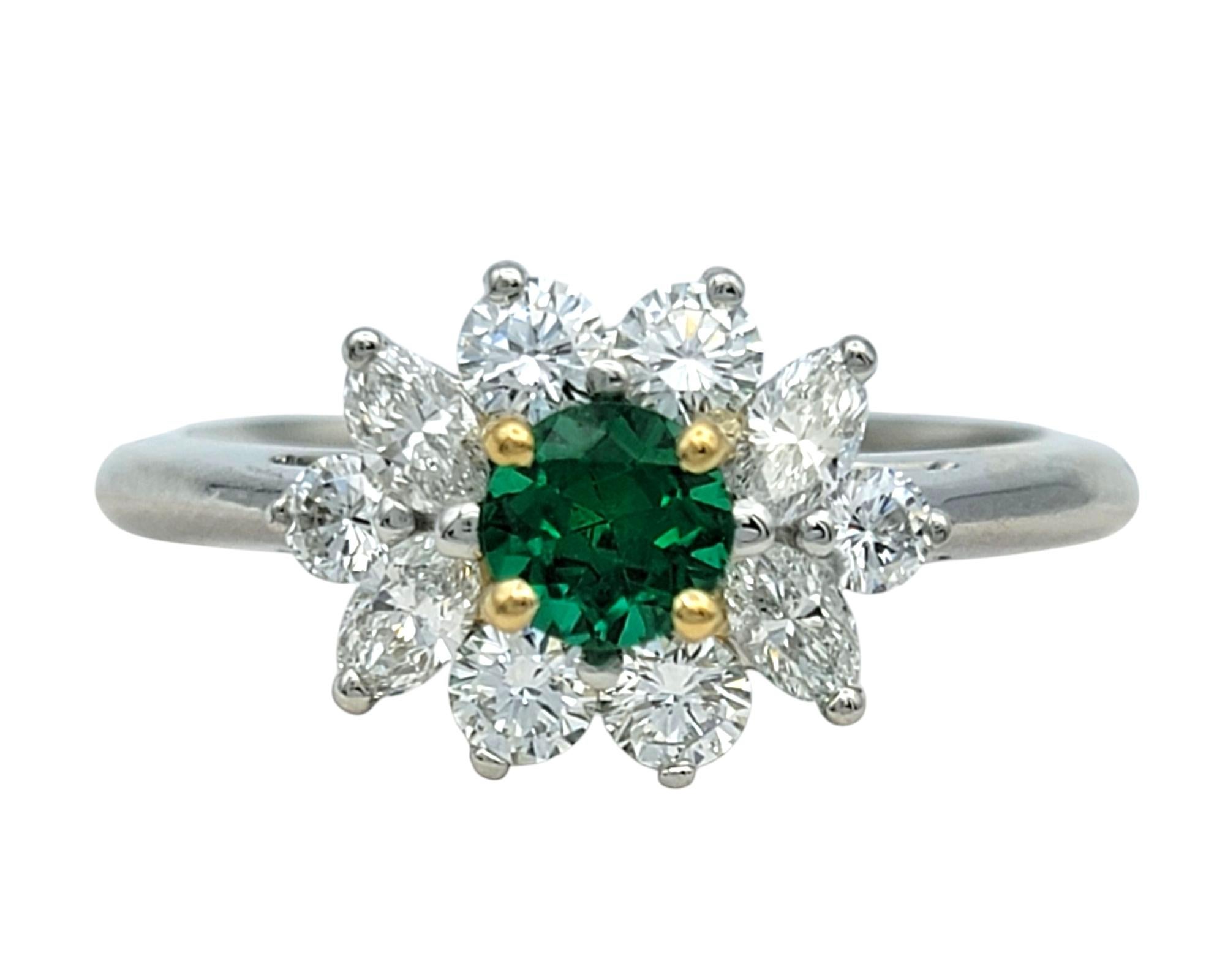 Ring Size: 6

Celebrate timeless elegance with this Tiffany & Co. Victoria Collection ring, featuring a vivid green emerald embraced by a dazzling floral halo of marquise and round brilliant diamonds. The striking contrast between the rich green