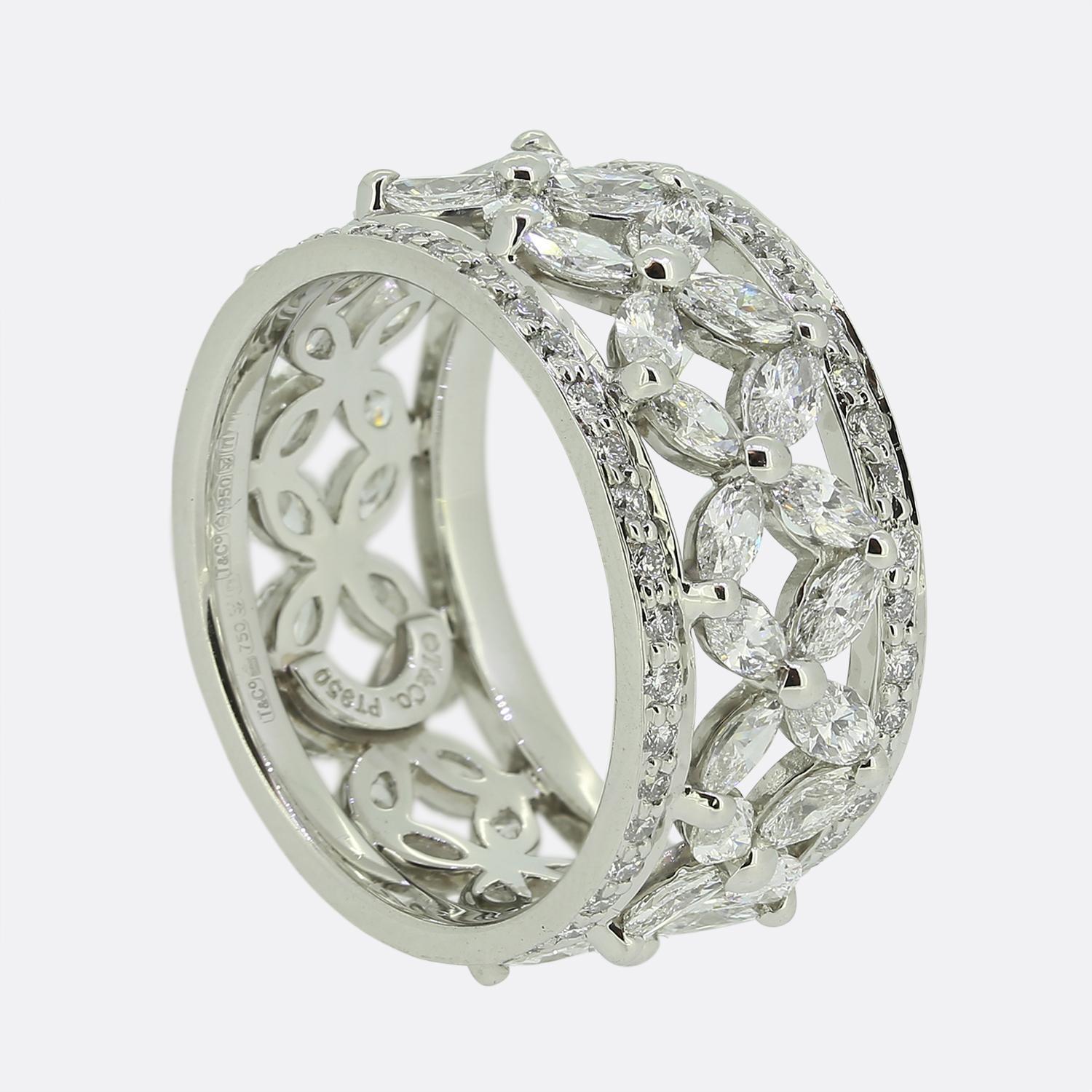 This is a truly stunning band ring from the world renowned jewellery designer Tiffany & Co. Crafted from platinum, the ring forms part of Tiffany's iconic Victoria collection and features an intricate design with radiant marquise-cut diamonds