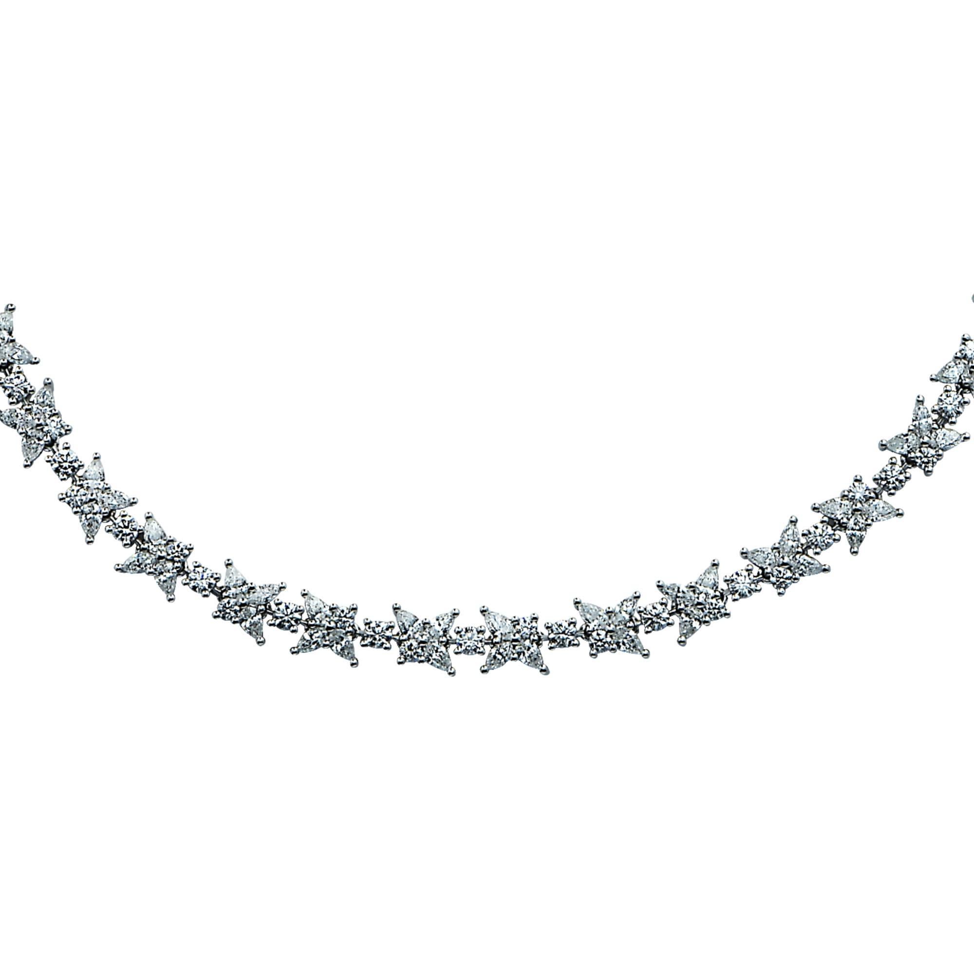 Distinctive Tiffany & Co. diamond cluster necklace from the Victoria collection, featuring approximately 20cts of mixed cut diamonds, D-G color, VVS1-VS2 clarity. This gorgeous necklace measures 17 inches in length by .30 of an inch. Each cluster