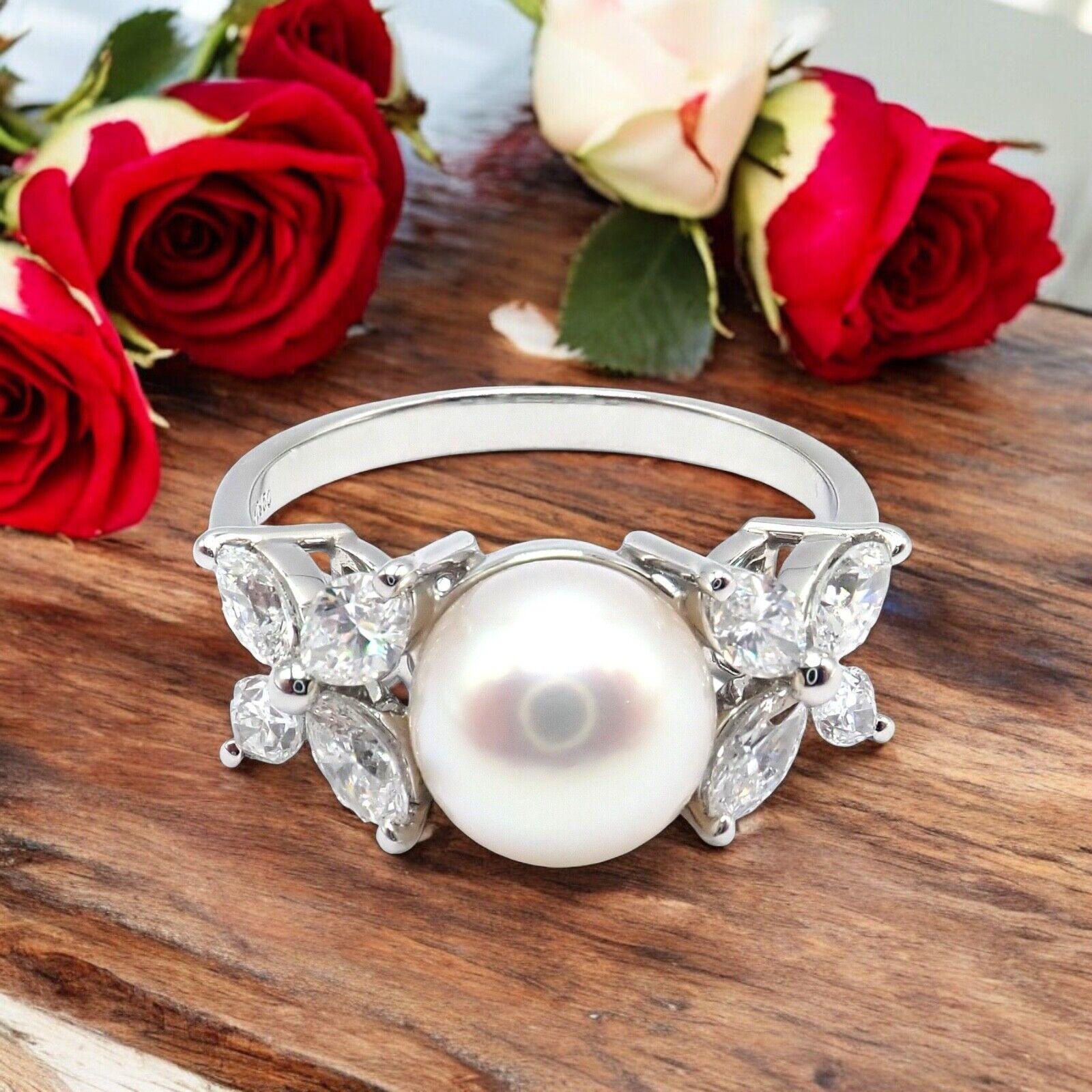 Platinum Victoria Diamond Pearl Ring by Tiffany & Co. 
The Tiffany & Co Victoria Platinum Diamond 7.5mm Pearl Band Ring is an exquisite piece. 
Crafted in platinum, it features a lustrous 7.5mm pearl surrounded by sparkling diamonds. 
This elegant