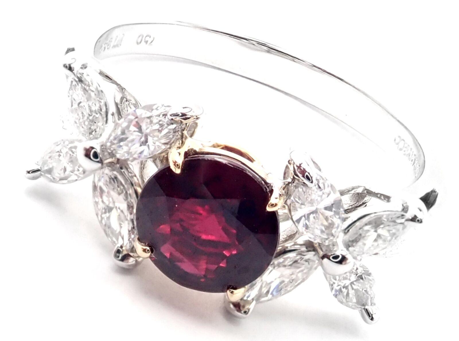 Platinum Diamond Sapphire Victoria Ring by Tiffany & Co. 
With 8 Marques cut diamonds VVS1 clarity, E color total weight approx. .60ct
1 ruby 5.8mm approximately .45ct
Details: 
Weight: 4.6 grams
Width: 9mm
Ring Size: 6.5
Stamped Hallmarks: