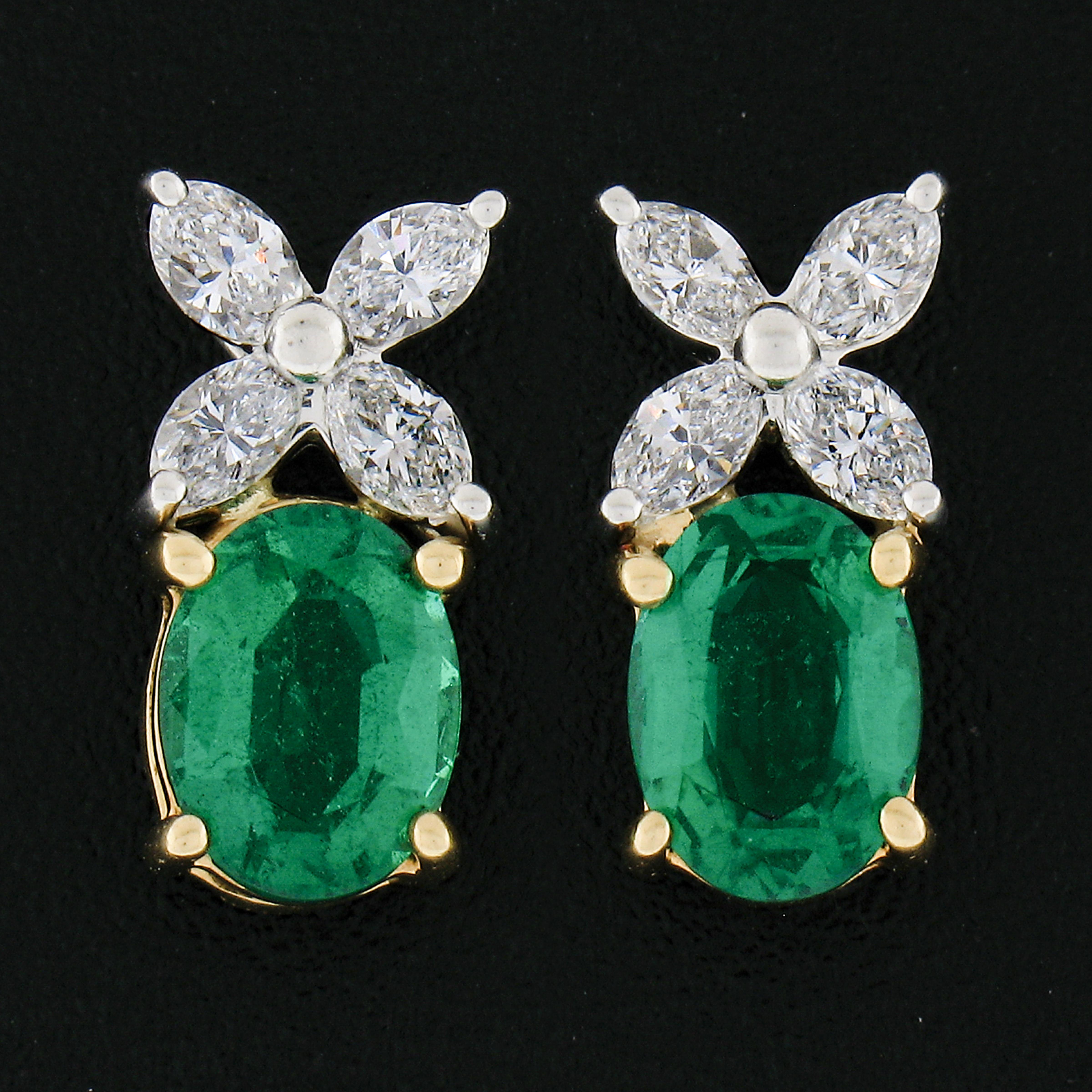 These fancy, Tiffany & Co., emerald and diamond drop earrings are crafted in solid platinum and 18k yellow gold and feature very well made prong settings that each elegantly embraces the gorgeous stones throughout. The beautiful, marquise cut