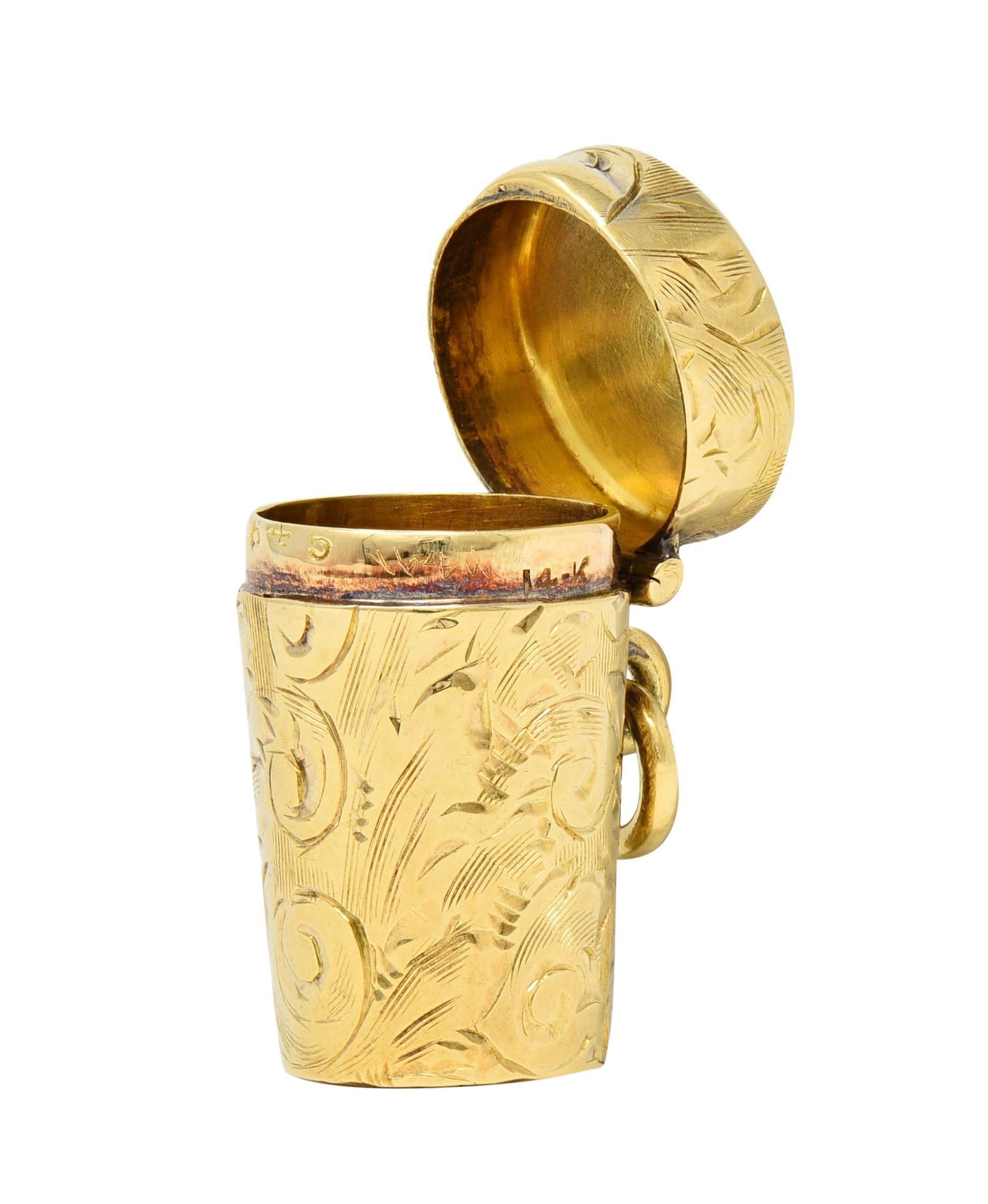 Designed as a cylindrical container - tapered with hinged cap 
Engraved throughout with scrolling sunflower motifs
With high polish finish and opens via grooved lip
Suspending from jump ring bale
Stamped for 14 karat gold
Fully signed or Tiffany &