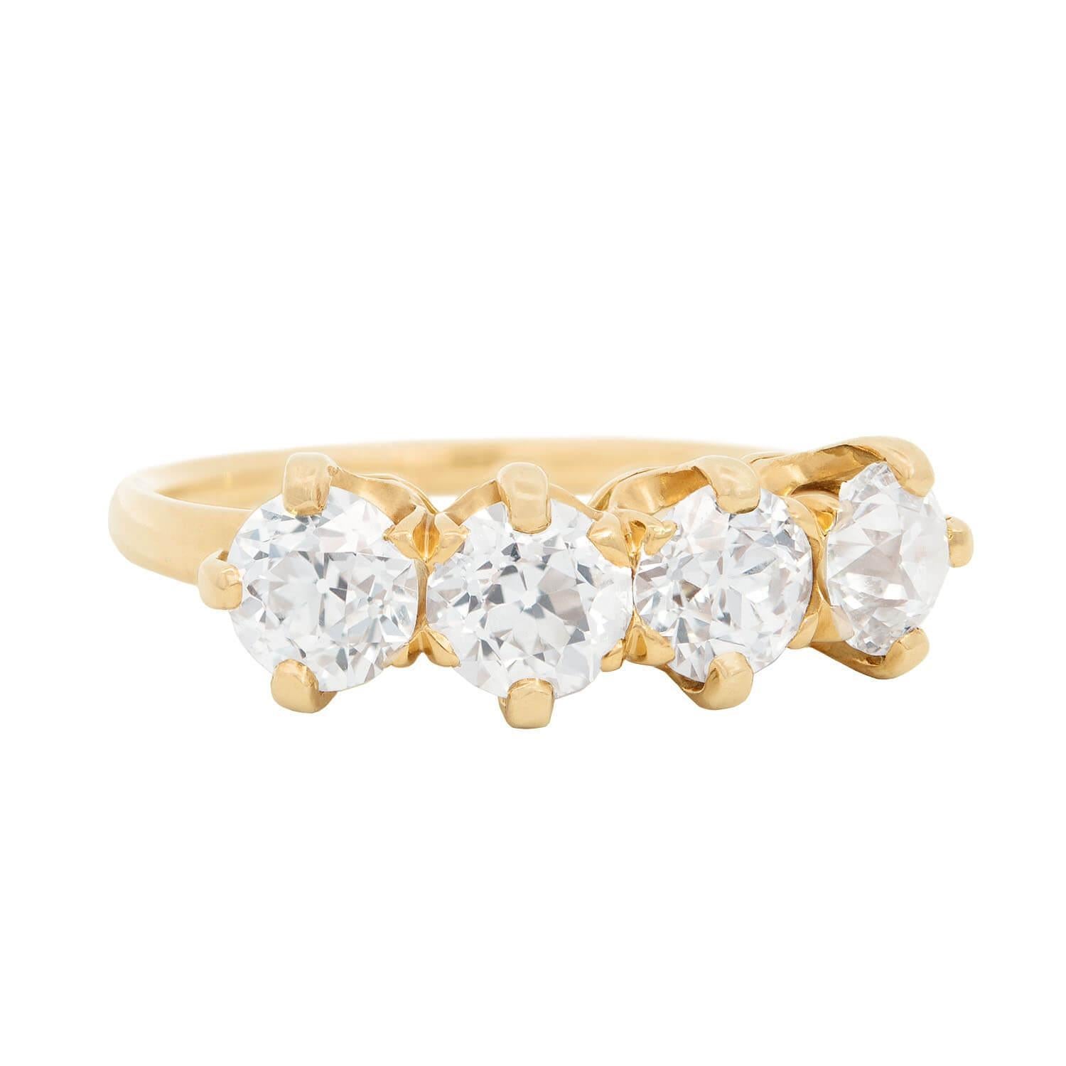 An exquisite Victorian (ca1880s) diamond engagement ring from legendary maker Tiffany & Company! Made of 18k gold, this gorgeous piece features four mine cut diamonds.  The diamonds are held within raised 5-prong setting and sits prominently atop a