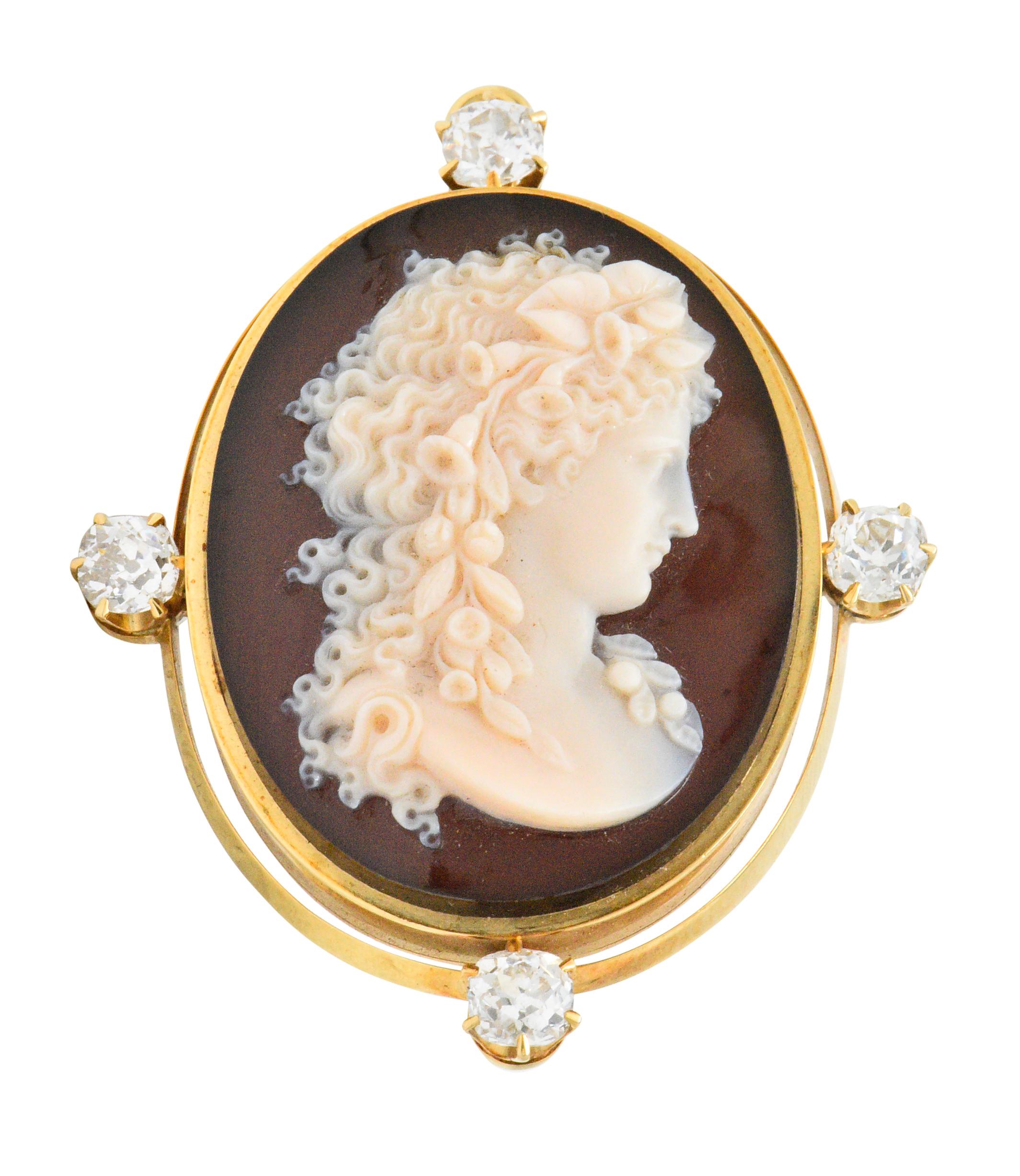 Carved banded agate depicting the profile of a woman 

Frame accented by four old mine cut diamonds weighing approximately 2.00 carats total, GHI color and VS to SI clarity

Exquisitely and expertly carved, depicting her demure downturned gaze and
