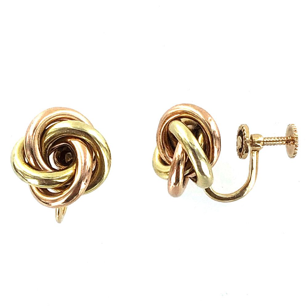 Tiffany & Co. vintage knot earrings fashioned in 14 karat yellow and rose gold. The knots measure approximately .50 inch in diameter and come with the vintage screw back non-pierced posts. Signed Tiffany & Co. Tiffany pouch included.