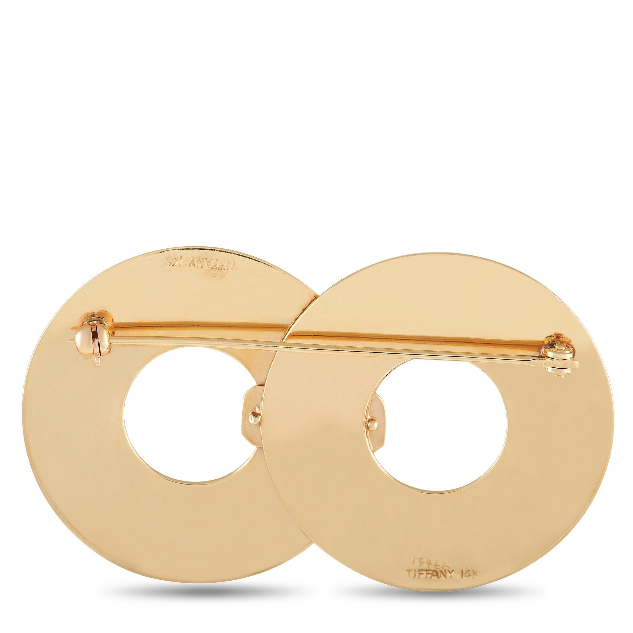 This vintage brooch from Tiffany & Co. is an exciting way to elevate any ensemble. Warm 14K Yellow Gold provides it with a lustrous finish, while a fluted surface adds extra visual impact to its understated design. It measures 2.15” long and 1.25”