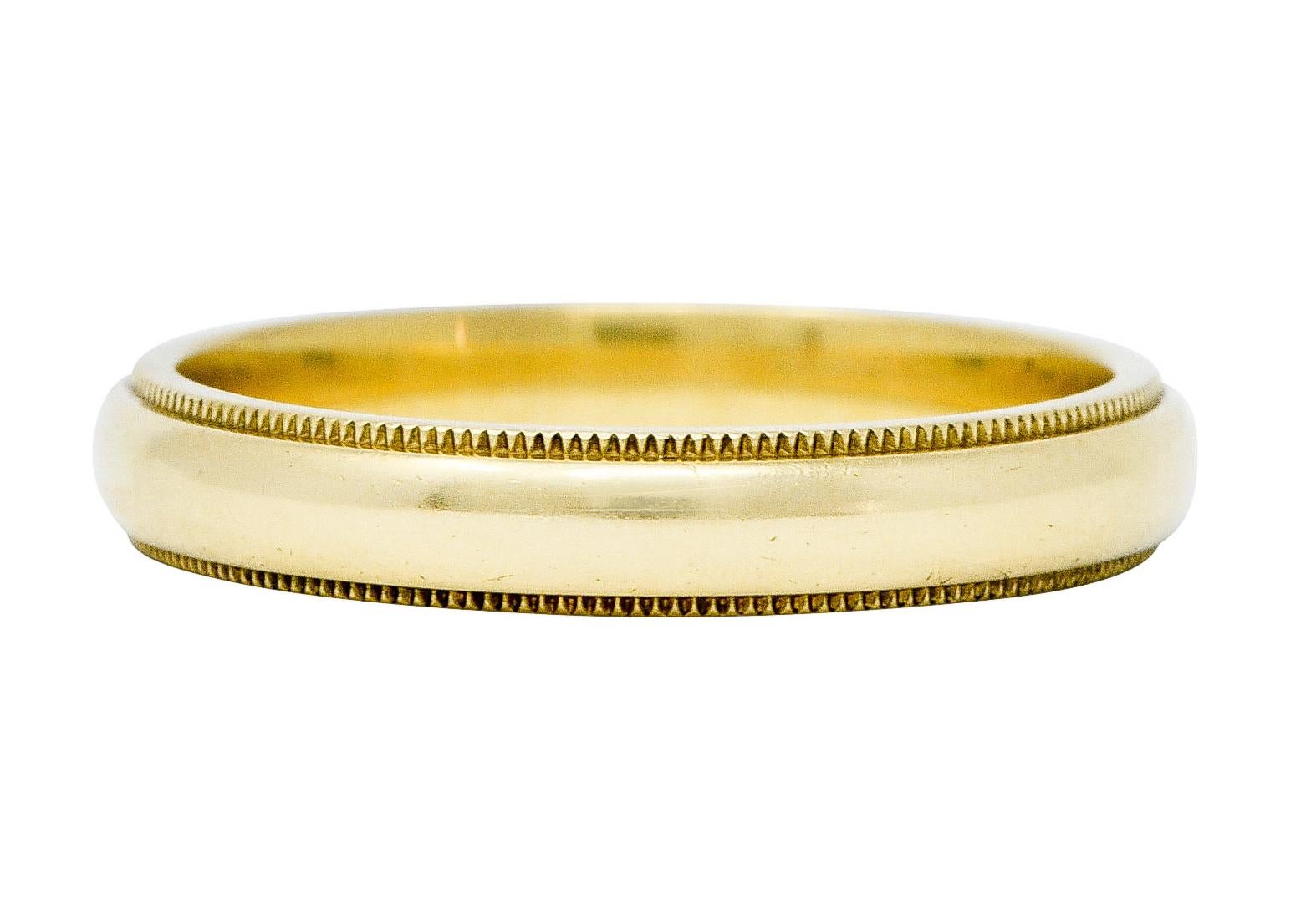 Designed as a gold band ring edged with milgrain

Stamped 750 for 18 karat gold

Fully signed Tiffany & Co.

Circa: 1980s

Ring Size: 10 1/4 & sizable

Measures North to South 4.0 mm and sits 2.0 mm high

Total weight: 6.7 grams

Timeless. Enduring.