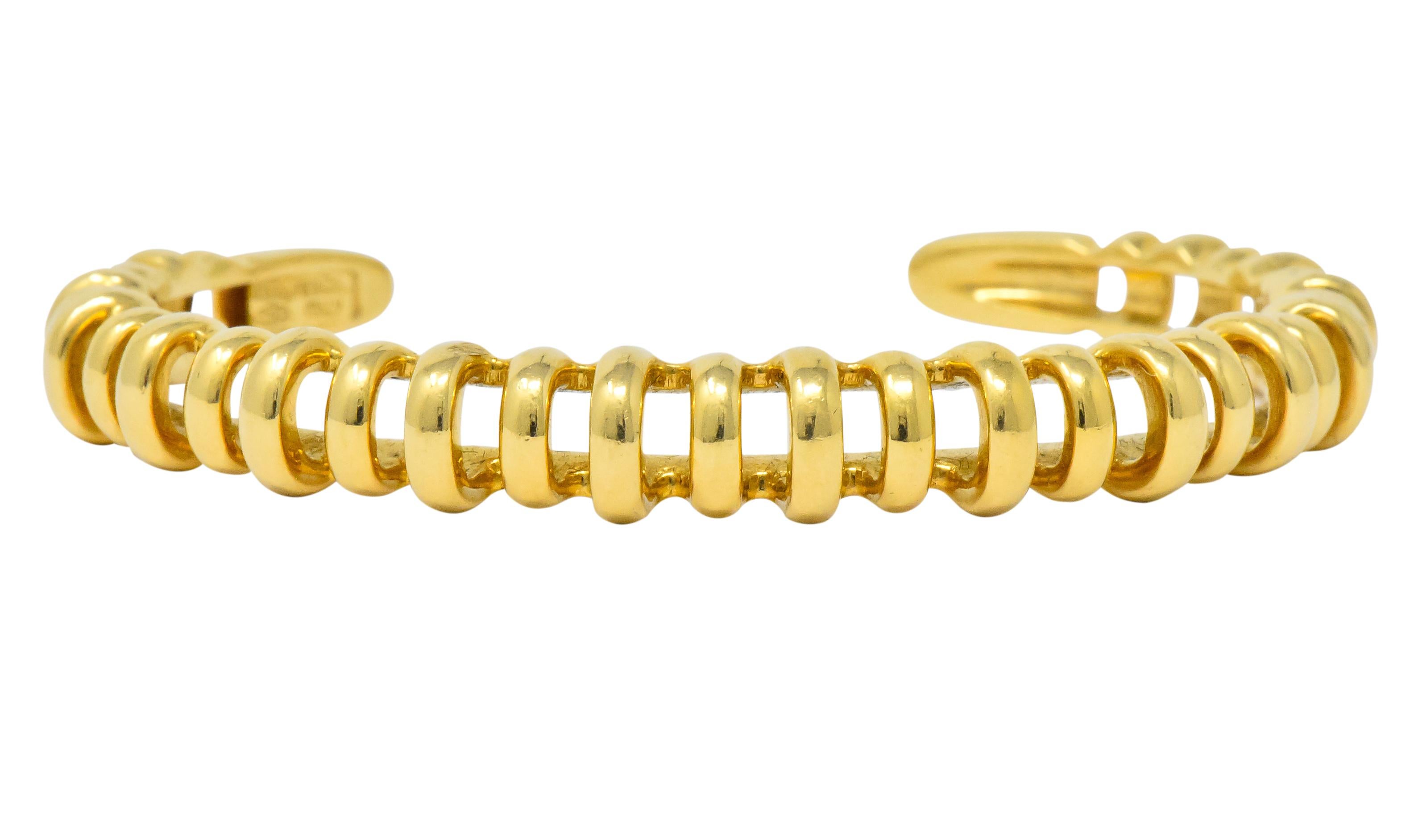 Designed as a high polished cuff 

Featuring pierced ribbed design alternating in height, and polished gold terminals

Fully signed Tiffany & Co.

Stamped 750 and Italy

Inner circumference: 5 3/4 inches

Width: 3/8 inch

Total weight: 26.9