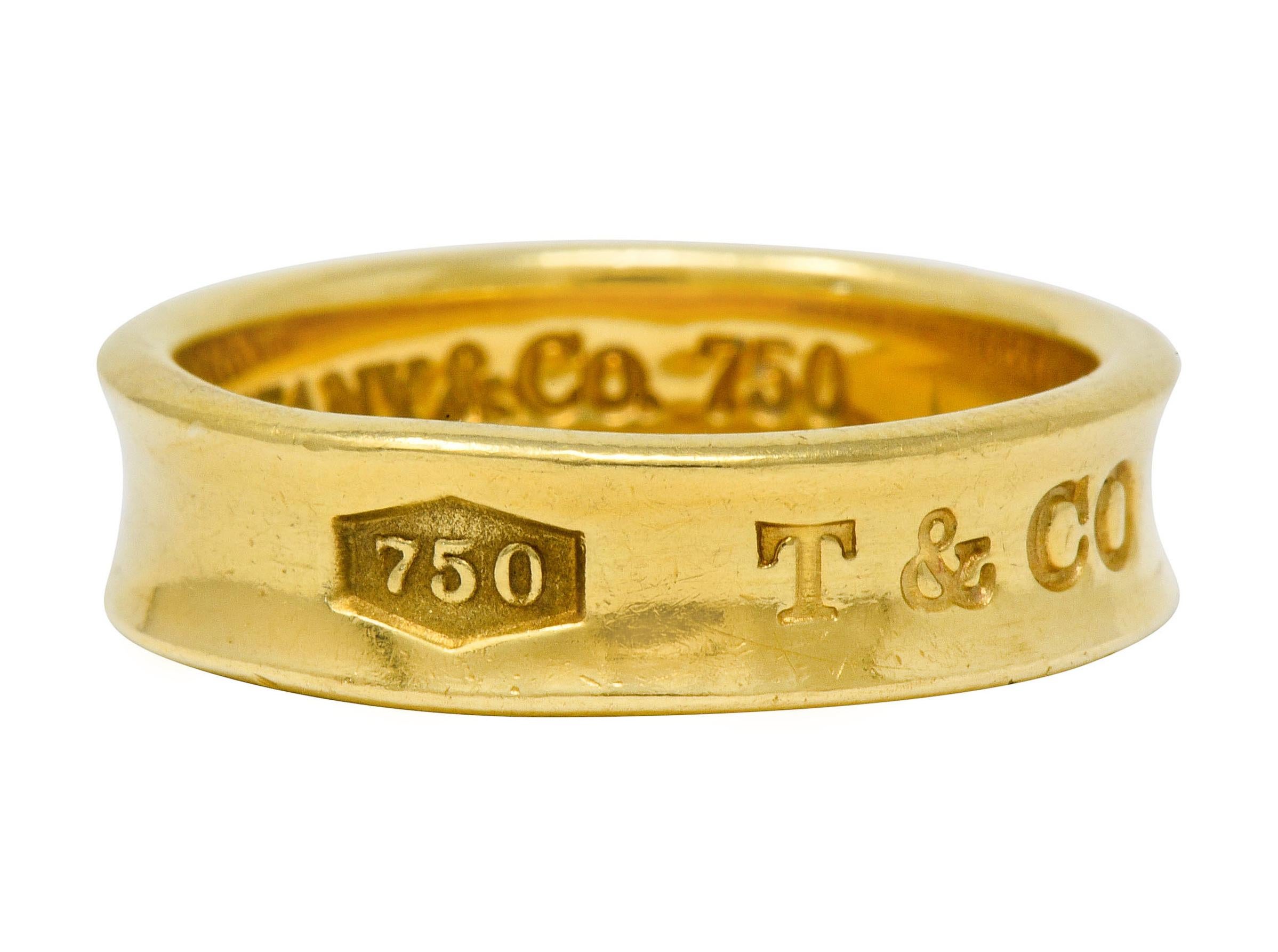 High polished gold band with recessed central groove

Deeply engraved to front 750, T & Co, and 1837

Inner shank fully signed Tiffany & Co. 1997

Stamped 750 for 18 karat gold

From the celebratory Tiffany 1837 collection

Ring Size: 9 1/2 & not