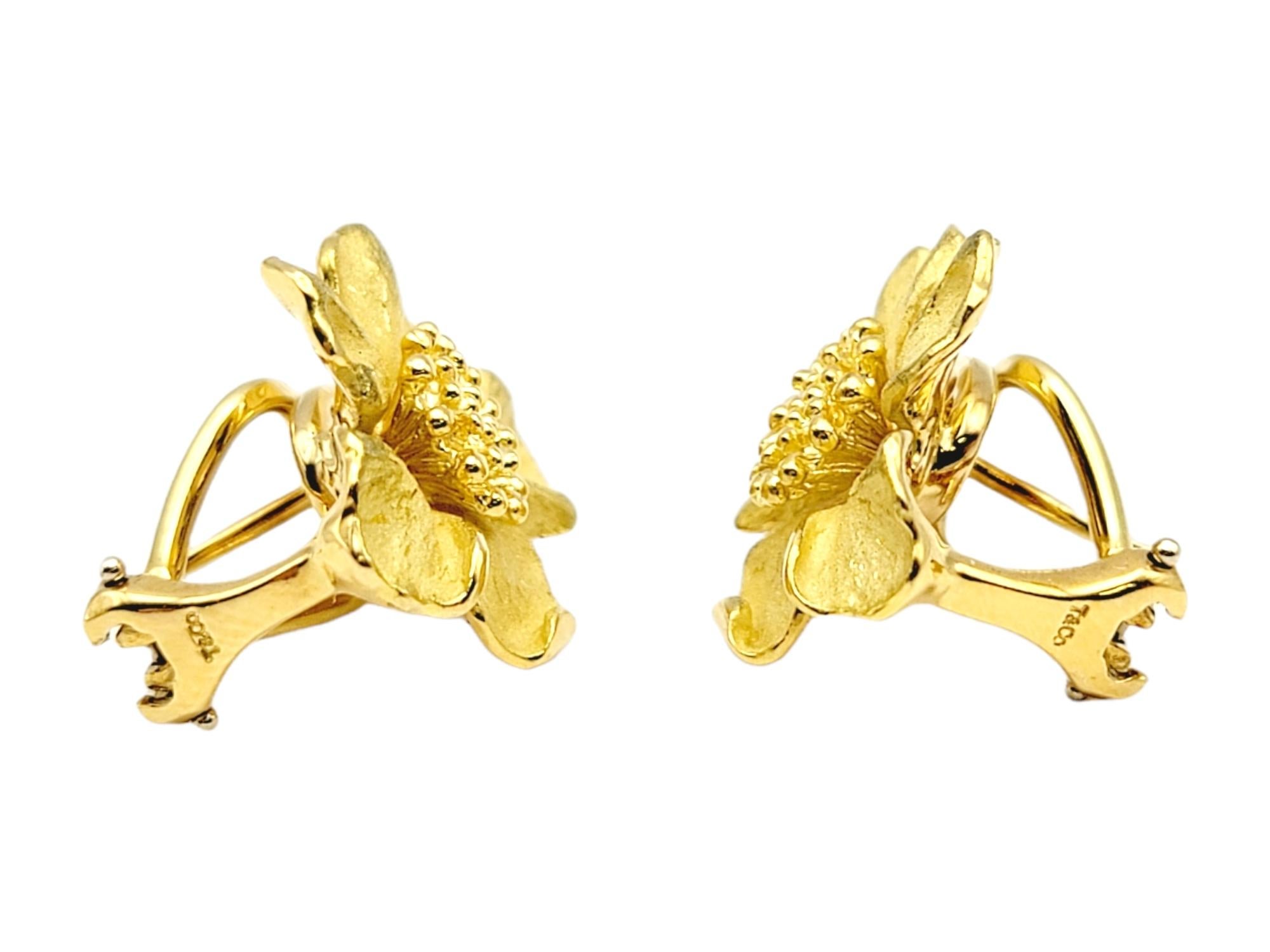 Stunningly detailed Tiffany & Co. dogwood flower earrings. Featuring a luxurious 18 karat yellow gold construction, the lifelike flowers are intricately carved and finished in an artful combination of brushed and polished gold. 

Metal: 18K Yellow