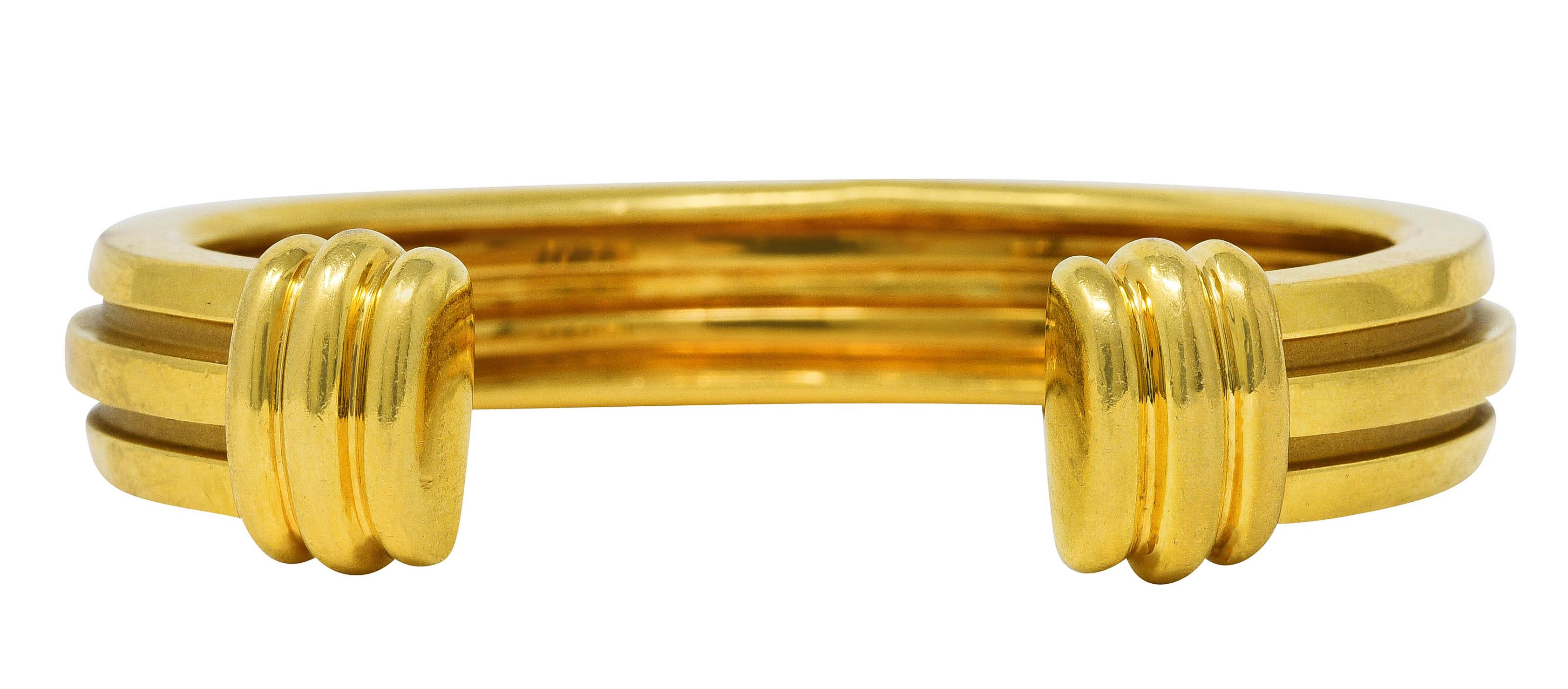 Cuff bracelet is designed as high polished gold band with two deep grooves

Completed by ridged terminals

Stamped 750 for 18 karat gold

Fully signed Tiffany & Co.

Circa: Stamped 1995 from the Atlas collection

Bracelet size: 5 3/4

Width at