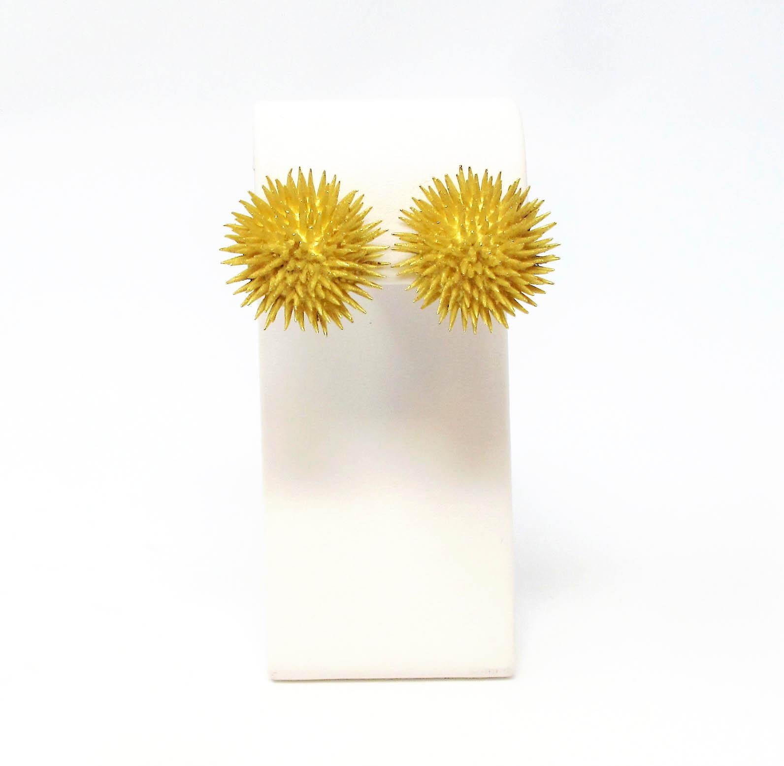 Incredible bold, vintage clip-on earrings from esteemed jeweler, Tiffany & Co. These chic, life-like sea urchin earrings are made of solid 18 karat yellow gold in a satin finish. The tiny spikes are slightly tapered with sharp, pointed ends while