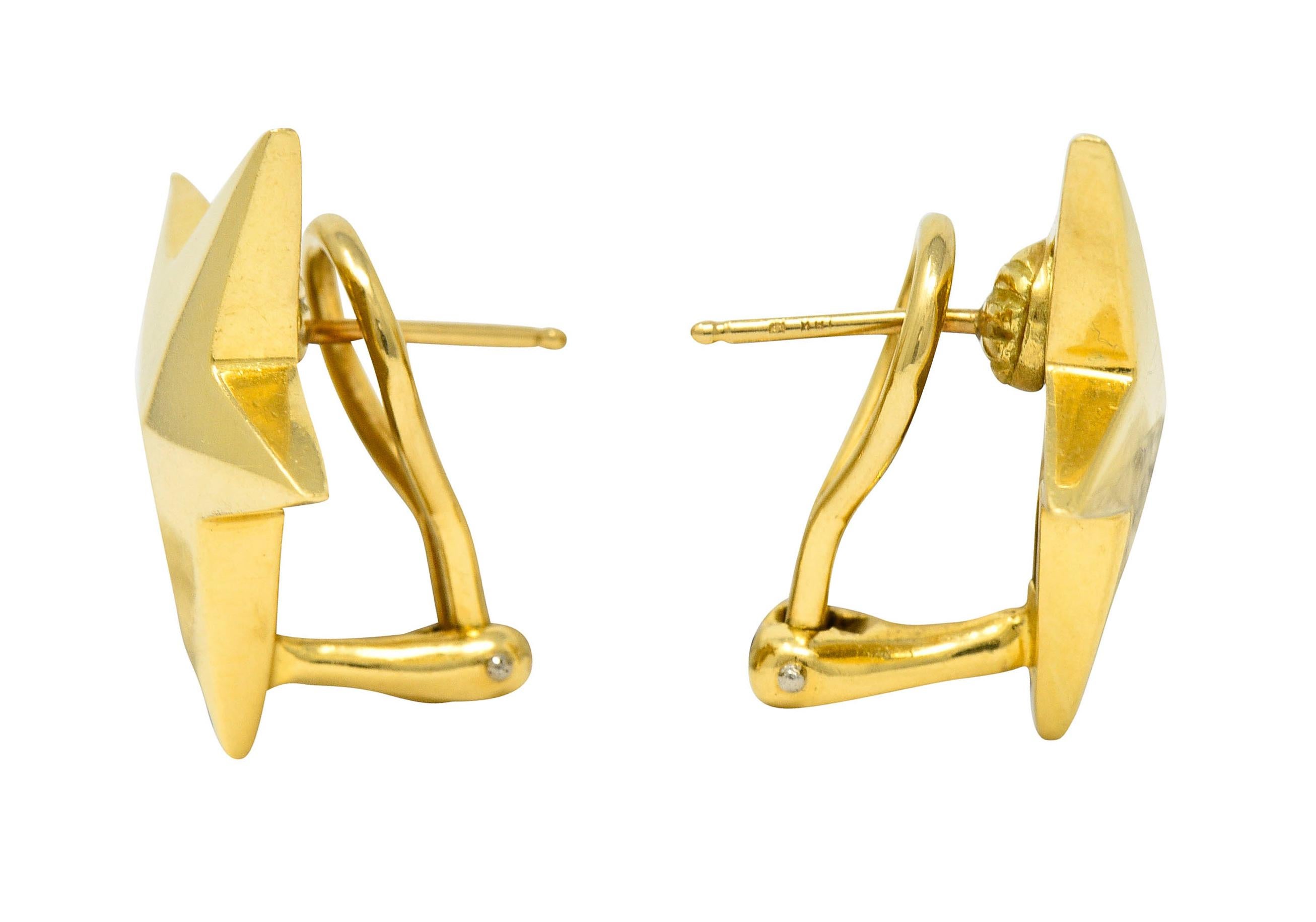 Earrings are designed as stylized stars with a slight pyramidal domed form

Featuring a brightly polished finish

Completed by posts and hinged omega backs

Stamped 750 for 18 karat gold

Fully signed Tiffany & Co. 1983

Measures: 13/16 x 1